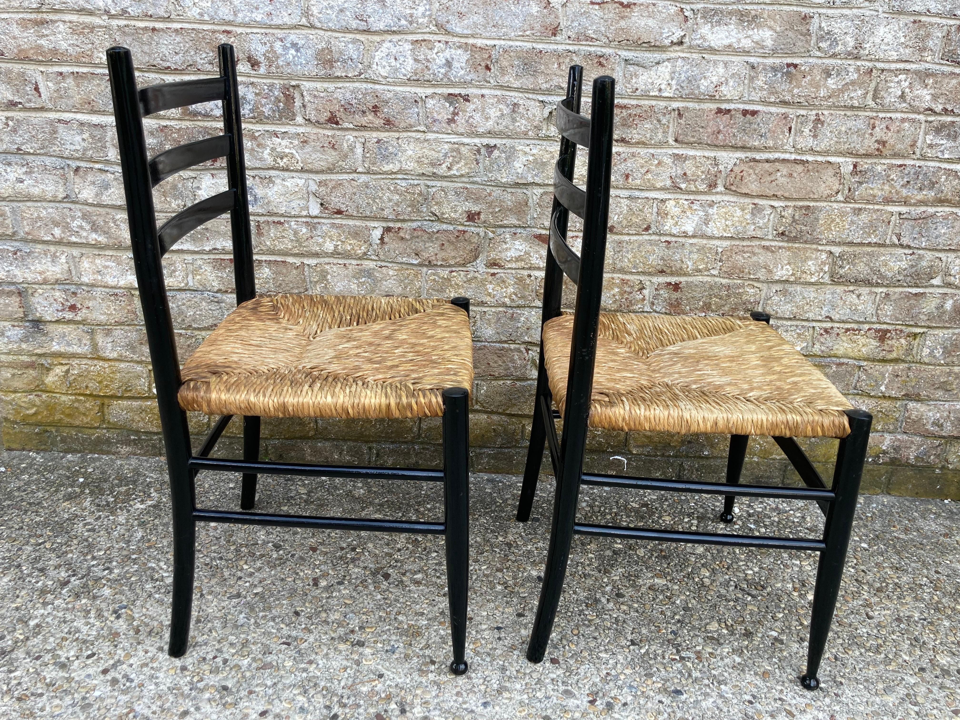 Elegant set of 4 rush seat black painted chairs... lovely carved foot.... probably French....