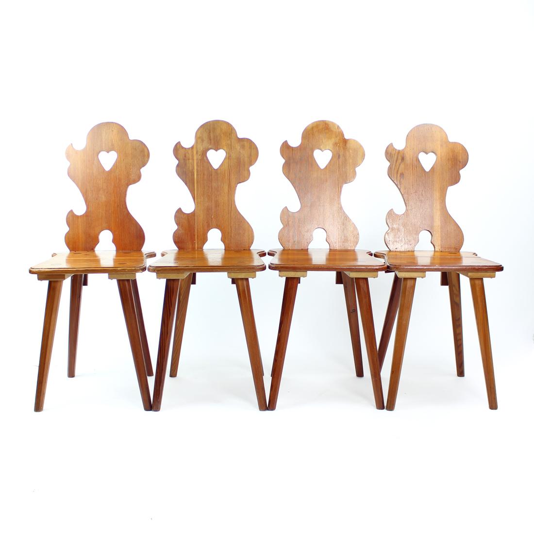 Beautiful set of four dining chairs produced in 1973 by LIPTA company in Czechoslovakia. The chairs are made of carved larch wood boards. The chairs show beautiful design originating in the Czechoslovakian folk style. There are beautiful carved