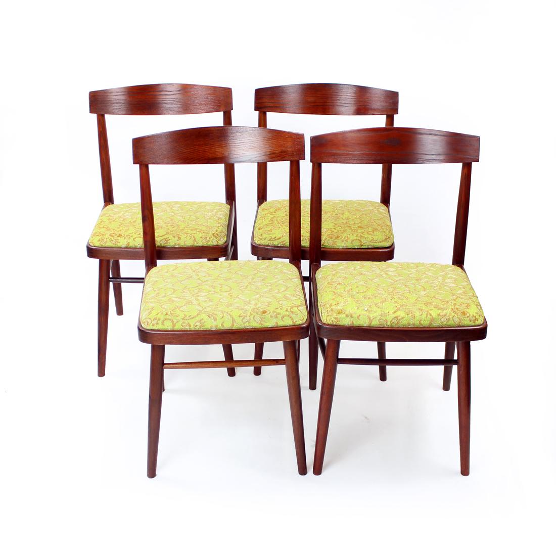 Set of four beautiful midcentury dining chairs produced by TON company in Czechoslovakia in 1960s. The original label still attached. The chairs are made of oak wood in mahogany shade of stain. Completely restored wood. The seat is in an original