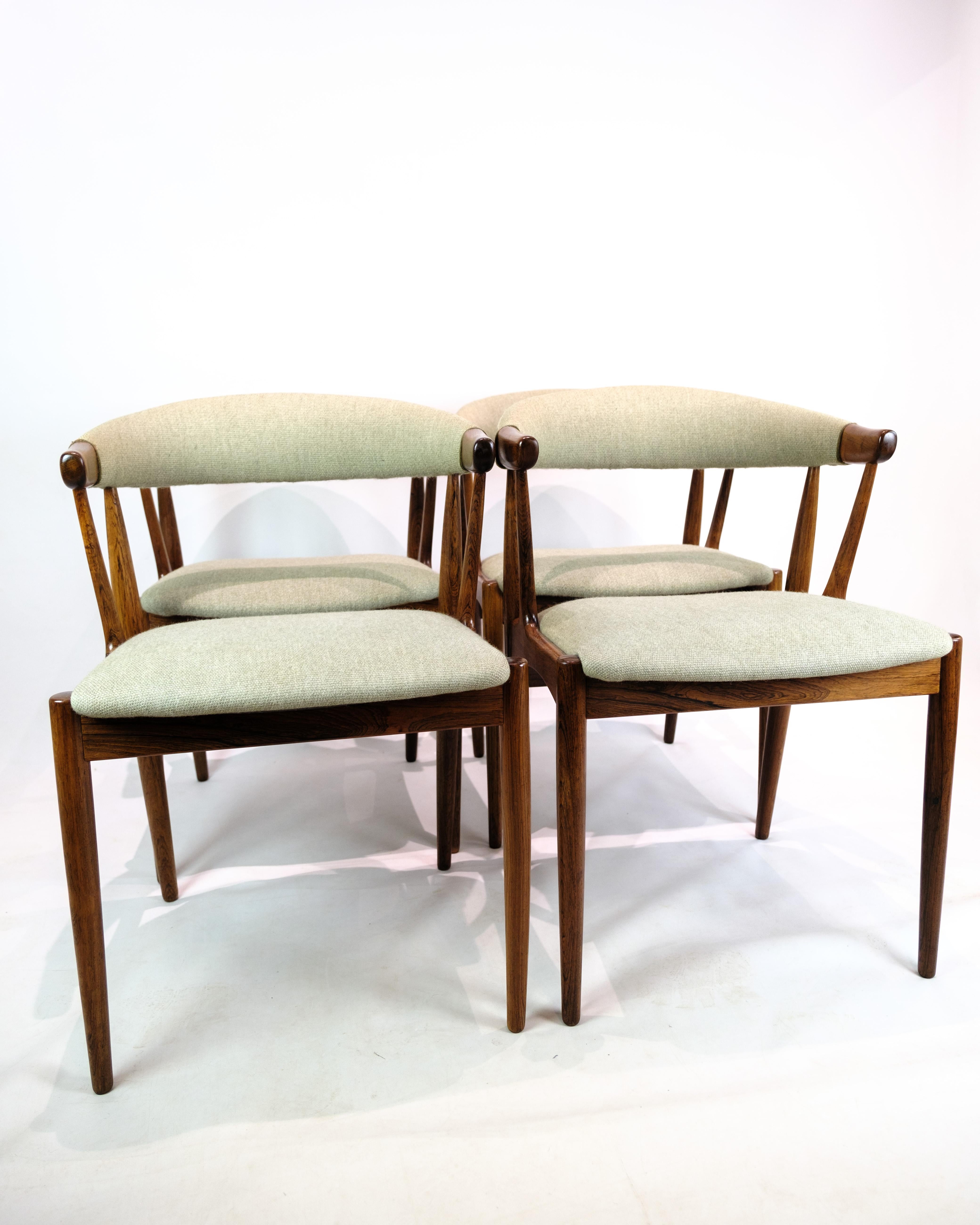 Set of 4 dining chairs in rosewood, upholstered in Hallingdal fabric, designed by Johannes Andersen in the 1960s. Johannes Andersen is known for his elegant furniture design that combines function and aesthetics. These chairs, with their beautiful