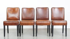 Set of 4 dining chairs made of sheepskin finished with black piping