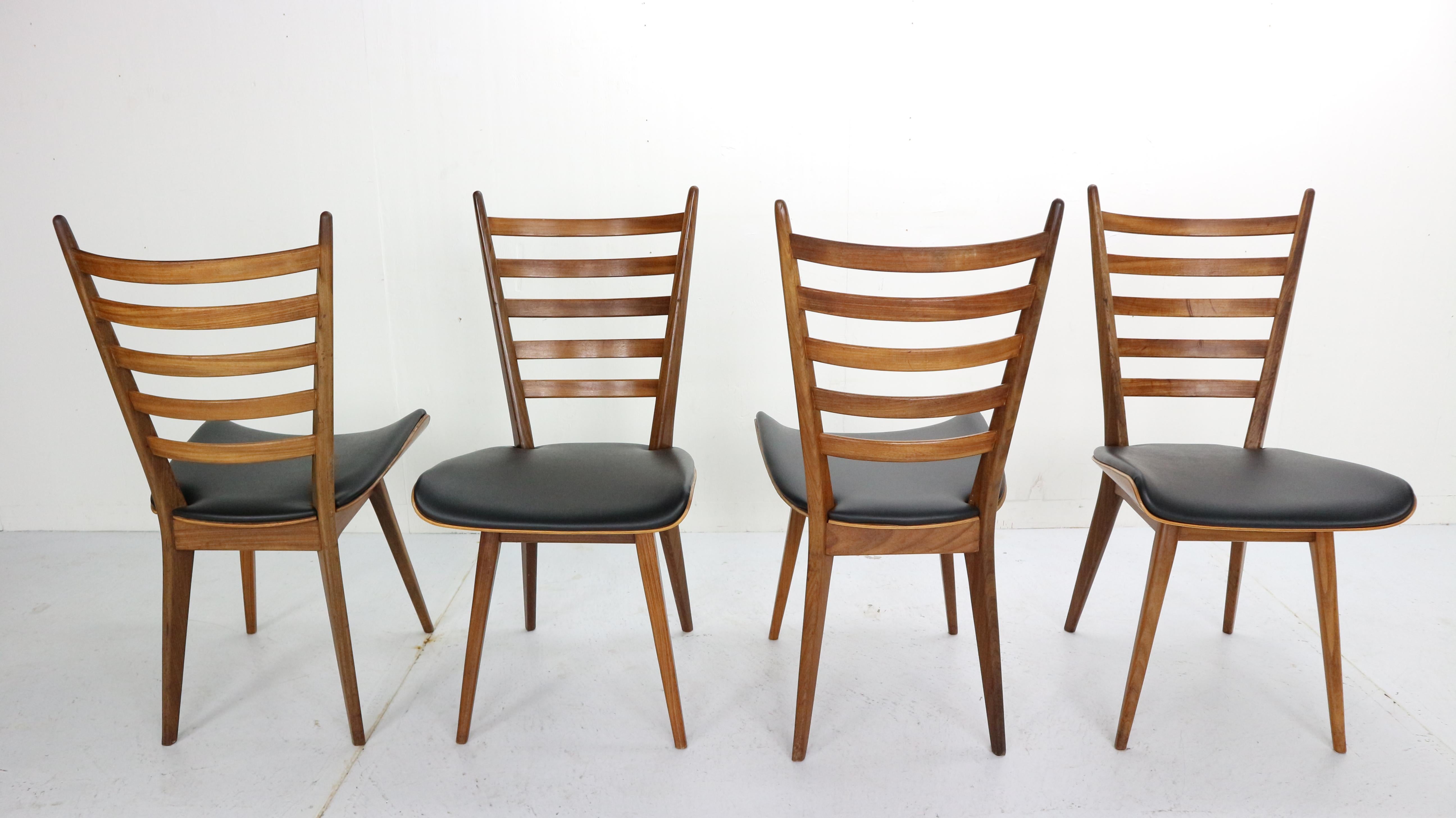 Set of four modernist chairs designed by Cees Braakman in the 1960s. Manufactured in the Netherlands by Pastoe.
These chairs has a large curved seating back and it's made of African teak wood.
Seats are covered with black faux