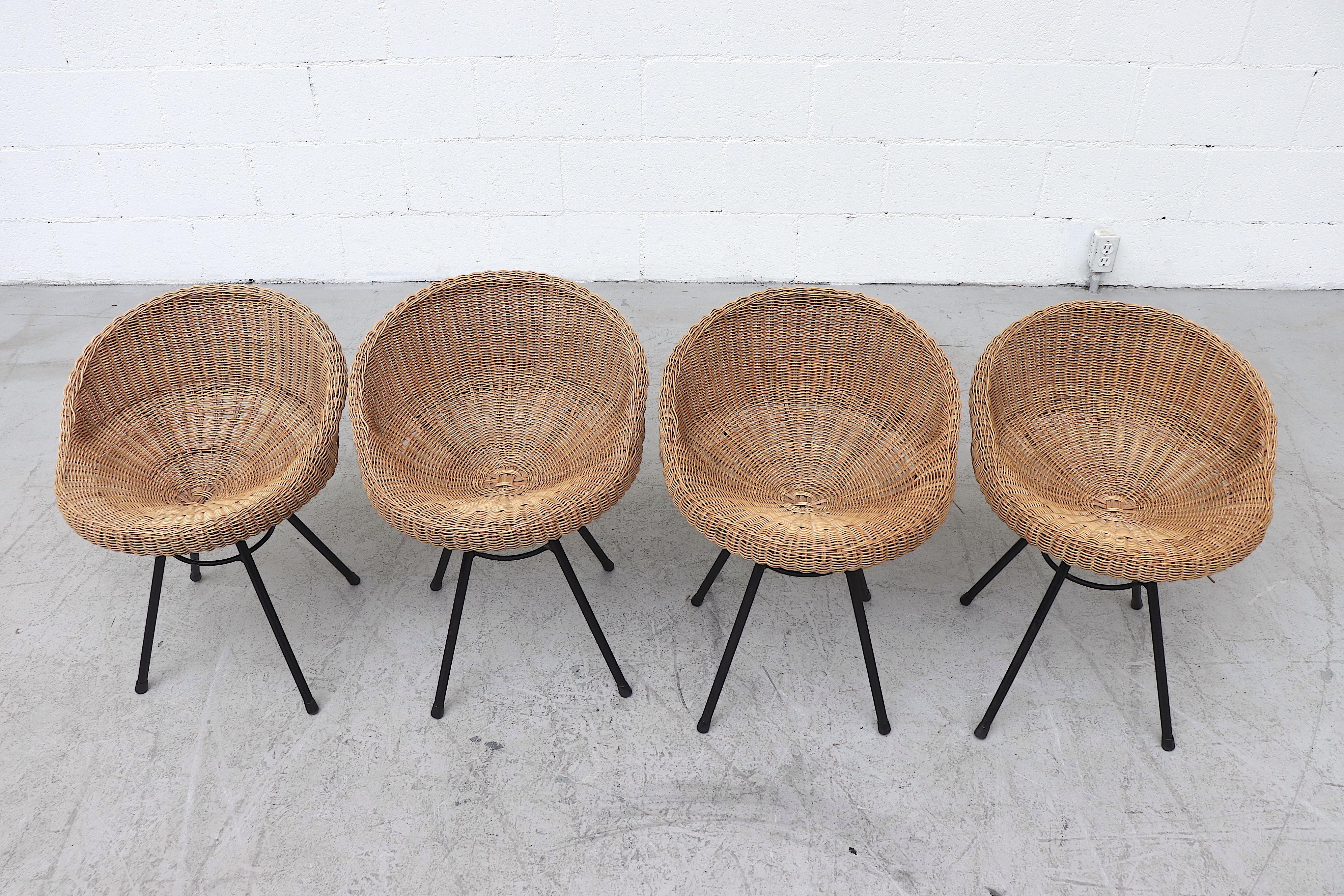 Handsome set of 4 rattan bucket stools with black enameled wire legs. In original condition with minimal breakage and some visible wear to enamel. Set price.