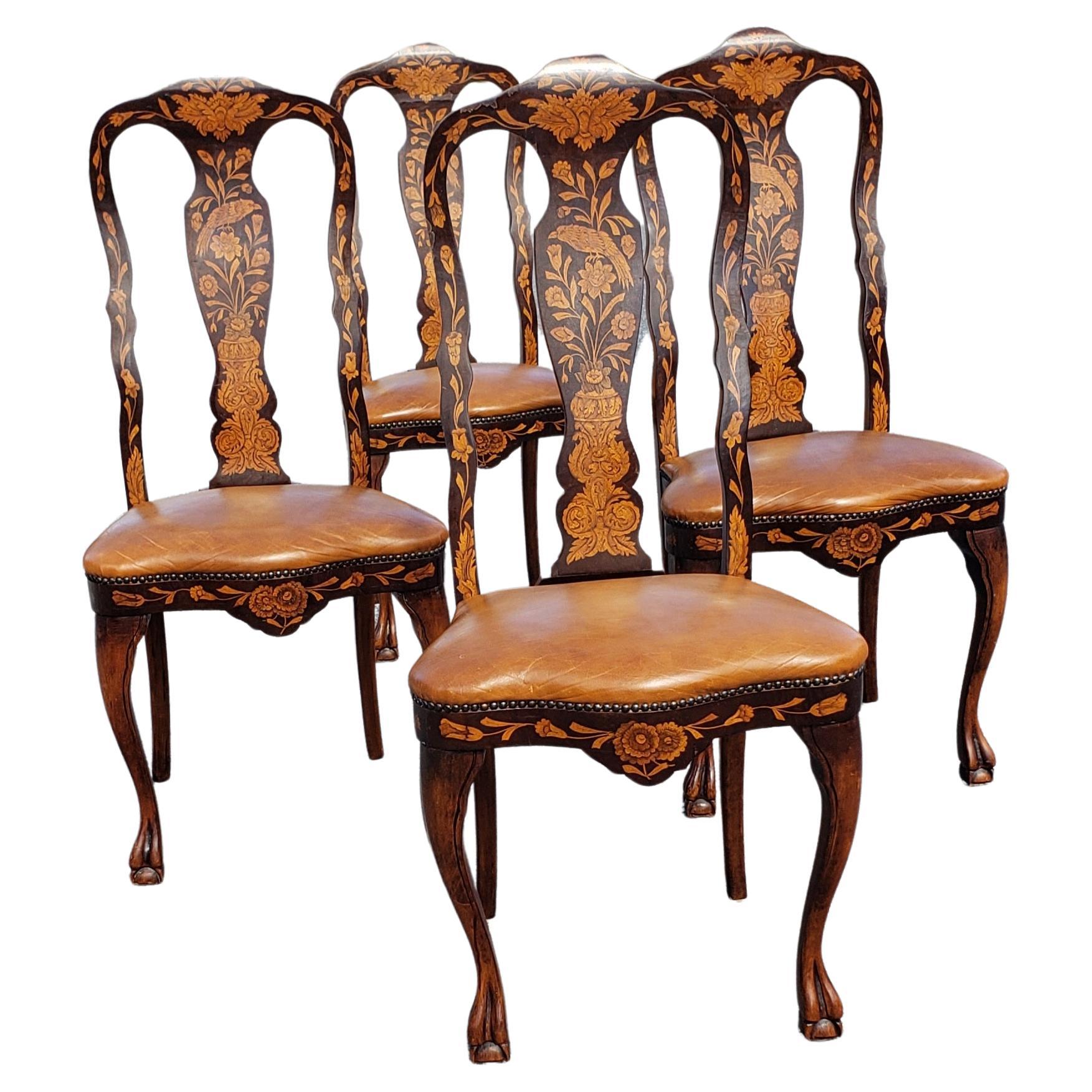 This exquisite set of four mahogany and satinwood Ducth marquetry dining chairs with top and soft grain leather seats offer a sophisticated presence for any upscale home. Newer, solft leather seats. Measures 21