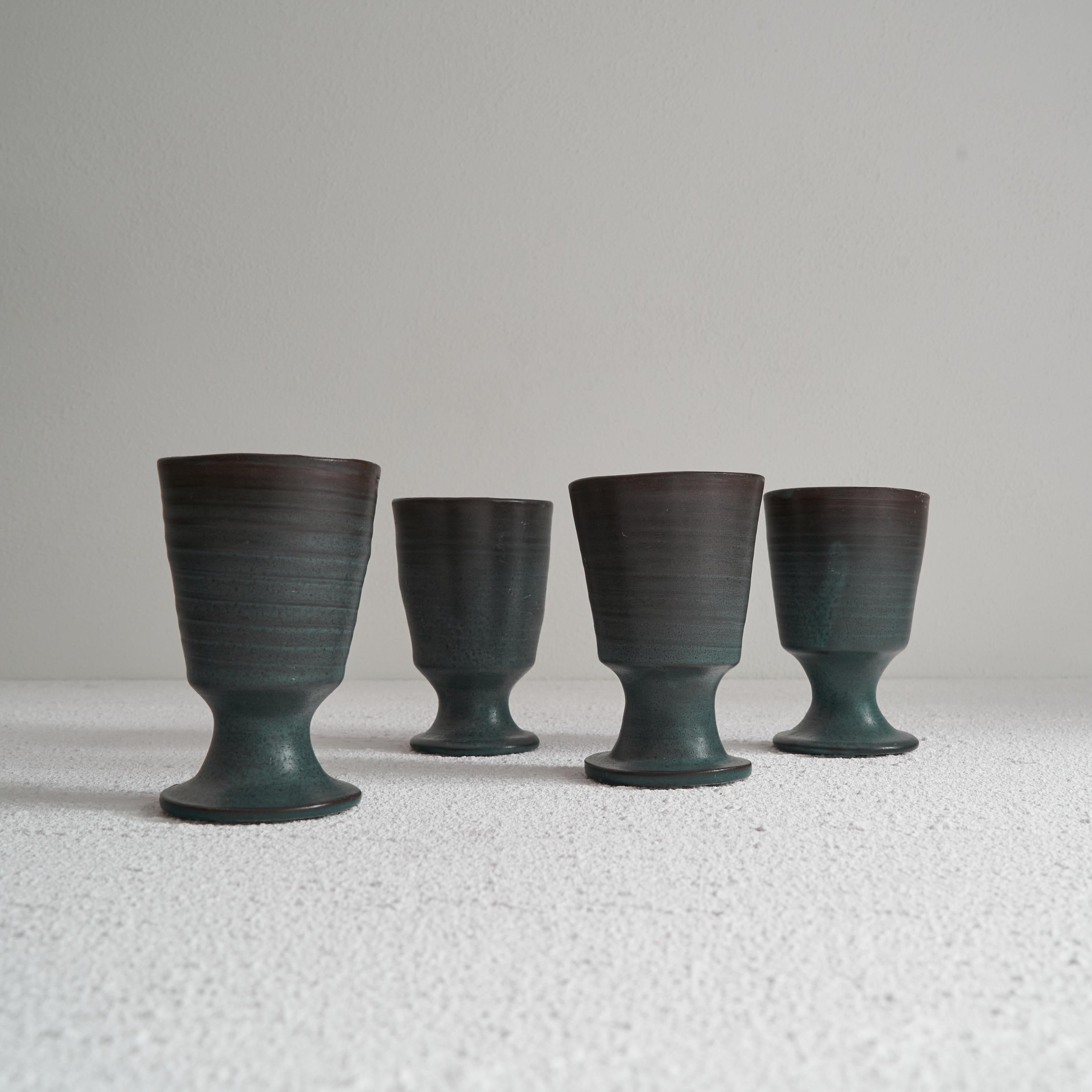 Set of 4 Dutch mid century Studio pottery Goblets. The Netherlands, mid 20th century. 

Wonderful set of 4 studio pottery goblets made in the Netherlands, somewhere in the middle of the previous century. Great shape and color, shifting from green