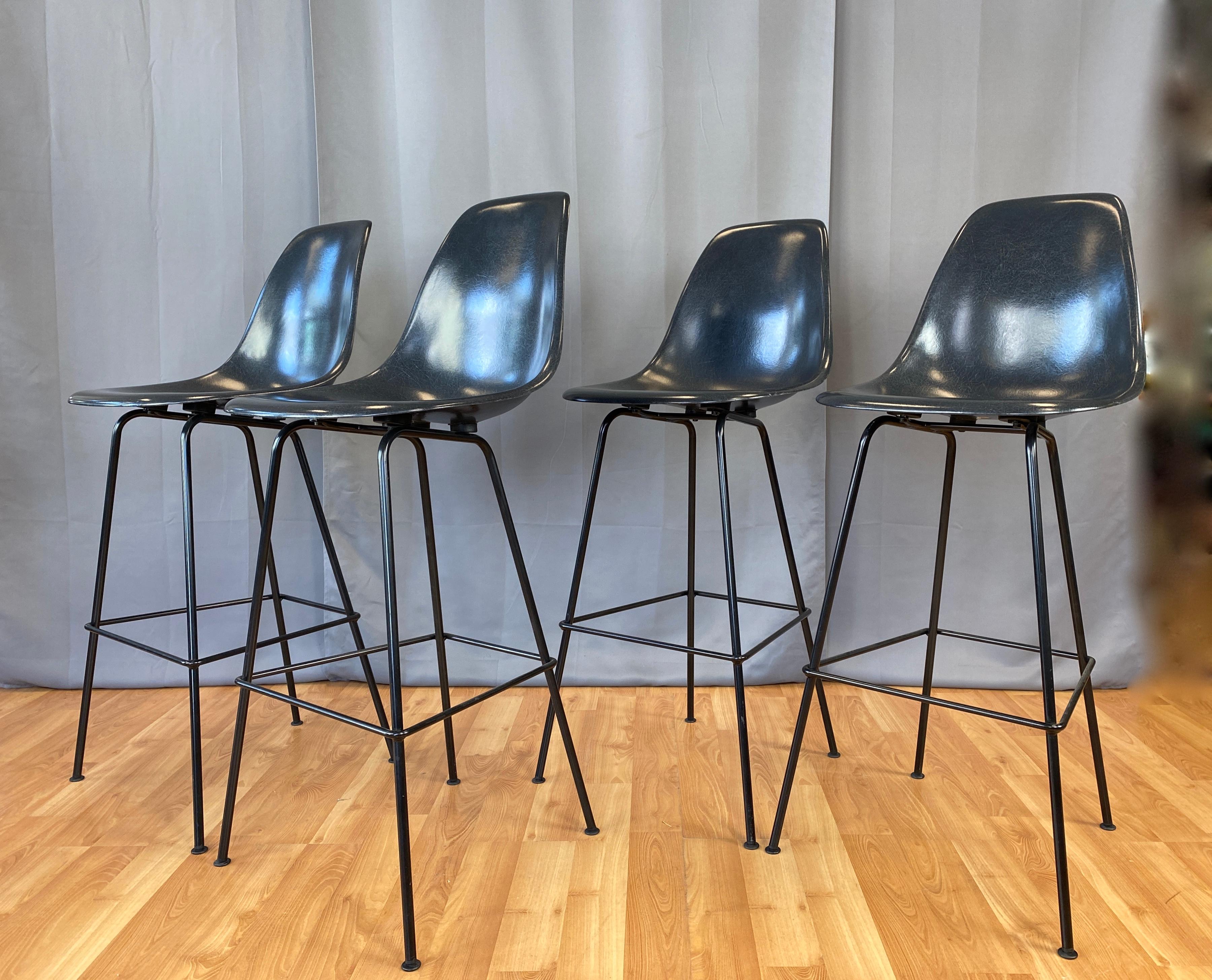 Offered here is a set of four molded fiberglass bar stools, in a dark grey. Eames for Herman Miller
Believe the color is called elephant hide leather, stools are on standard glides.