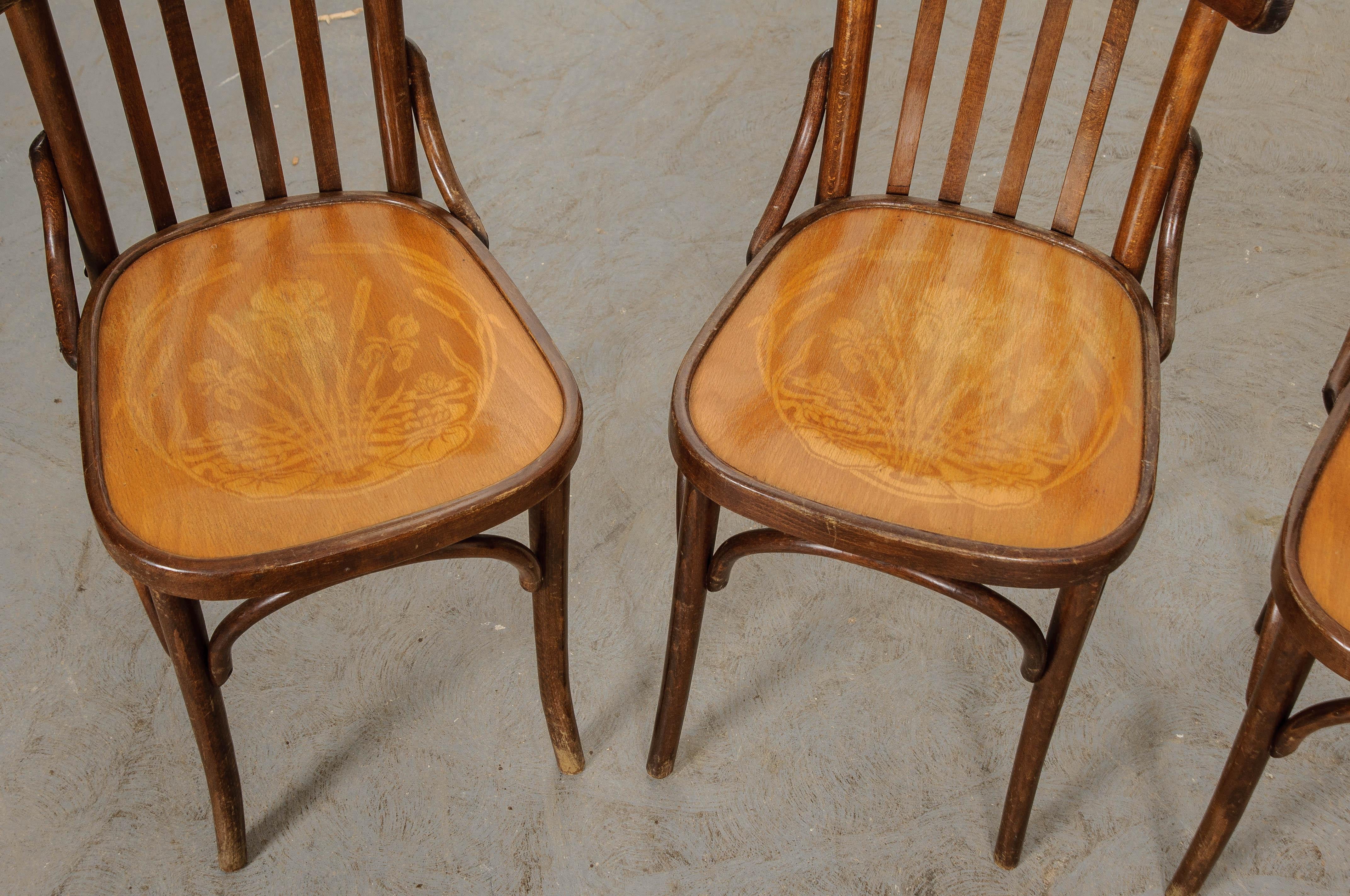 A charming set of French bentwood dining chairs from the early part of the 20th century. The oak chairs have a Classic bistro/cafe style that makes for wonderful dining chairs. The chairs’ seats have a lighter, more golden tone than the oak used to