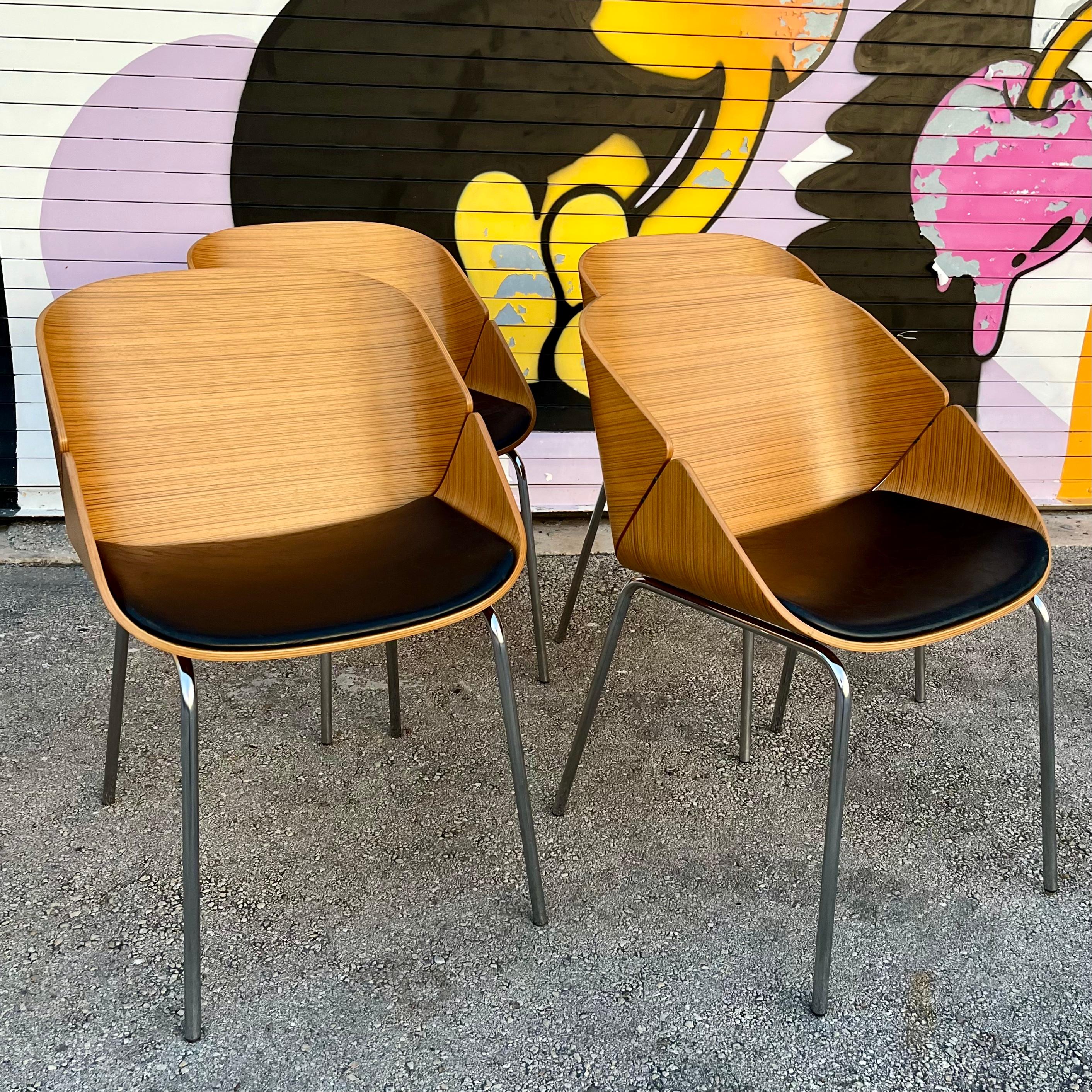 Set of Four Vintage Early 21st Century Babà Lounge/ Dining Chairs designed by Biagio Cisotti and Sandra Laube for Plank Furniture Italy. 
Feature a Mid Century Modern Design with a bent Zebra wood shell, Chrome legs, and the original textured faux