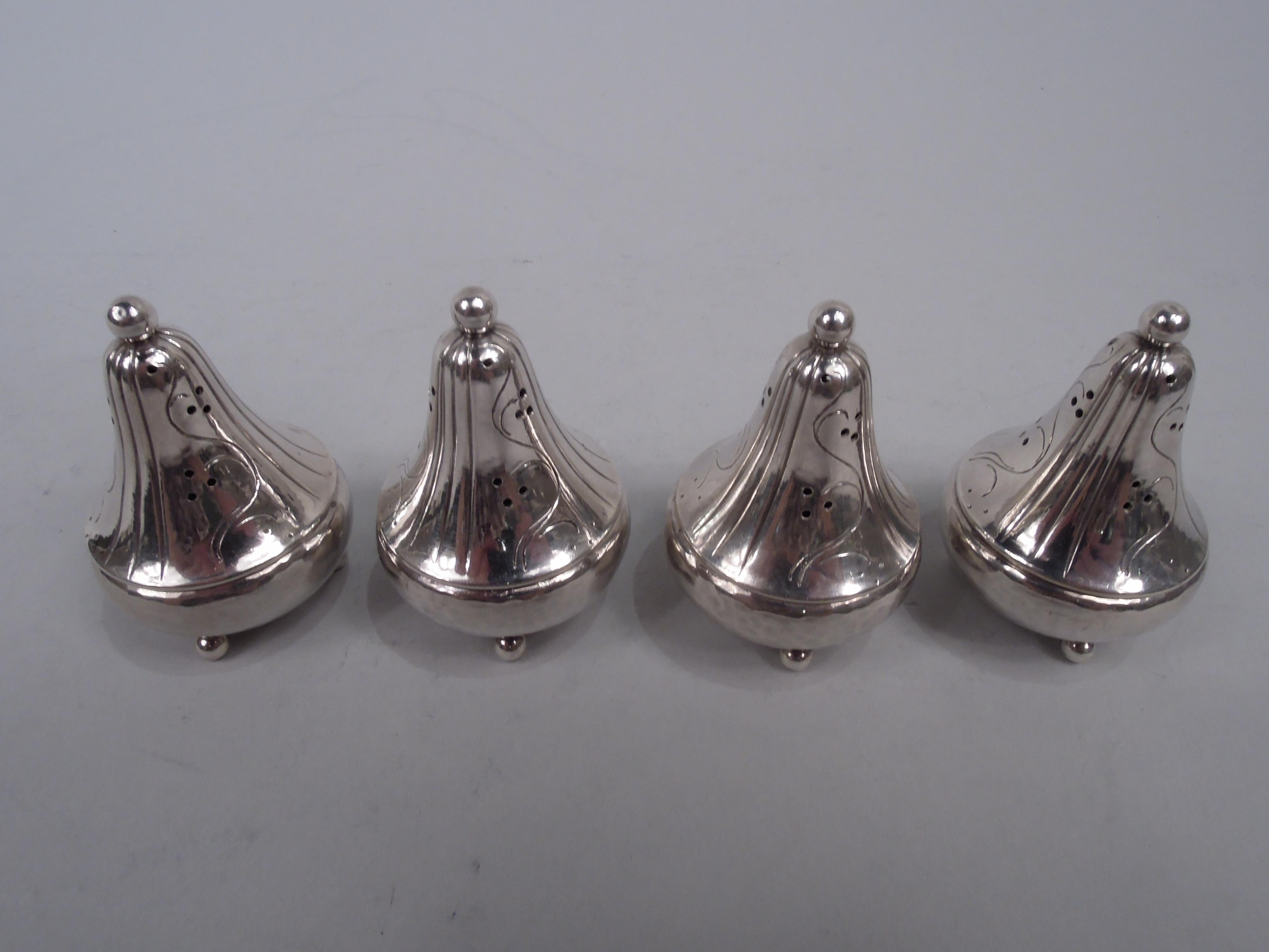 Set of 4 Danish Modern sterling silver pepper shakers. Made by Georg Jensen in Copenhagen. Each: Concial with ball finial and supports; alternating pierced scrollwork and flutes. First generation pieces ready for another century or two of dinner