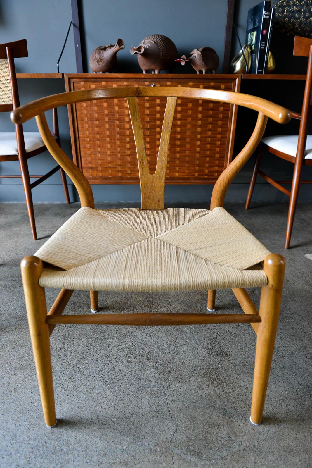 Set of 4 early original Hans Wegner CH24 Wishbone chairs, circa 1955. Hard to find early examples of Hans Wegner's Classic iconic CH24 wishbone chair. This set is very early, not modern re-issues, and from a one owner estate. All 4 match perfectly