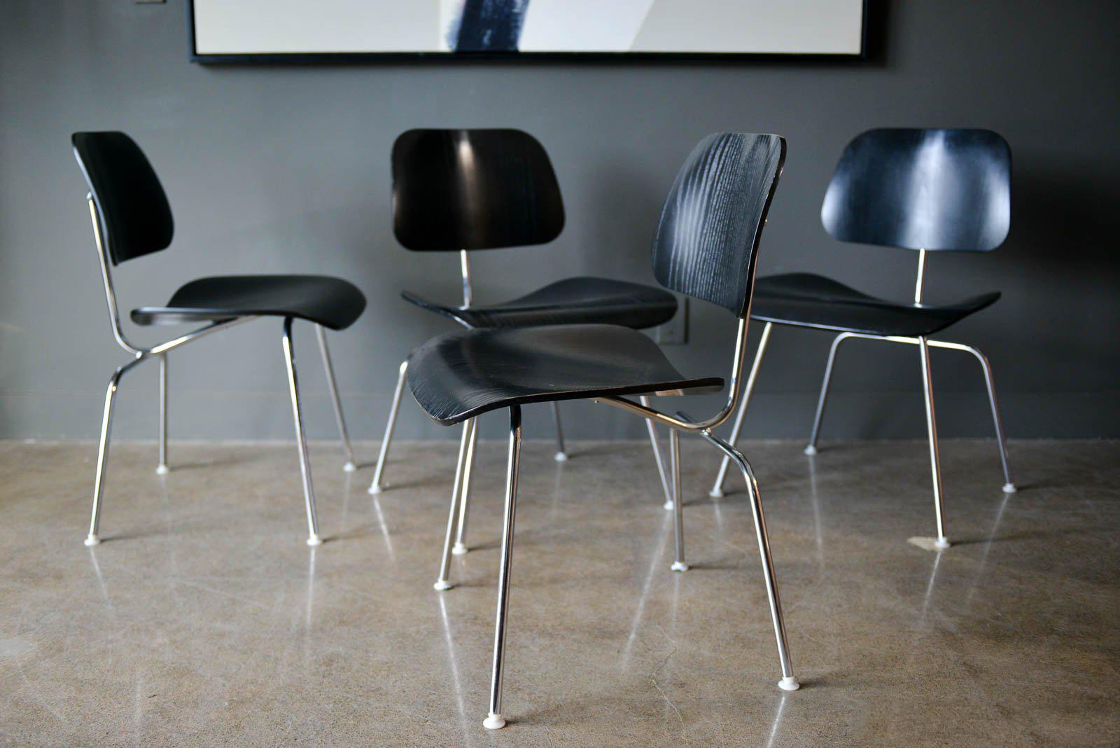 Set of 4 ebonized Eames DCM chairs, 2004. Excellent original condition with only slight wear to some of the edges. Ebonized finish with original floor glides. Marked with Herman Miller label, 2004.