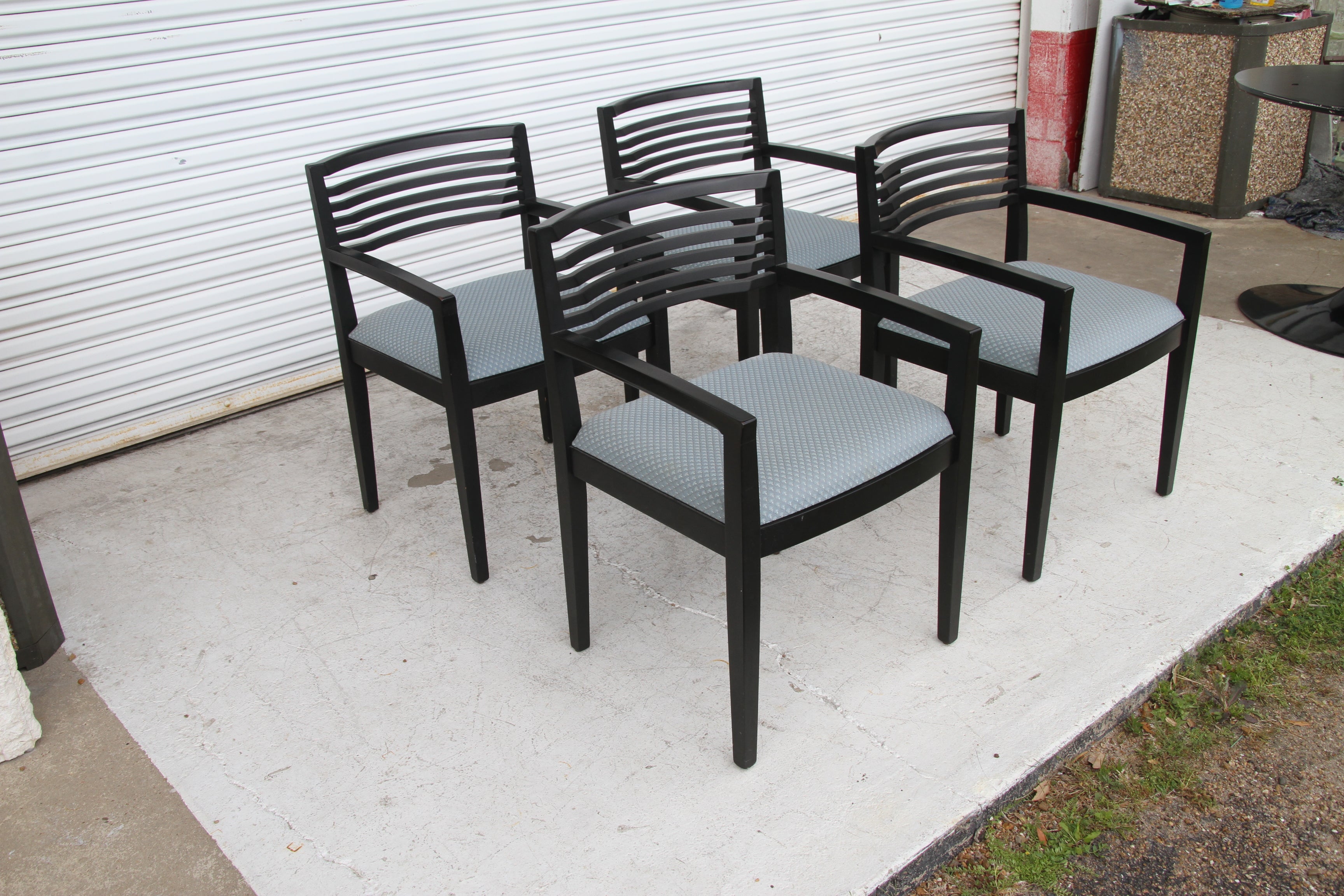 Set of 4 ebonized Knoll Ricchio chairs
1990

Winner of the 1991 Roscoe award for furniture design. 

Set of four ebonized dining chairs with upholstered seat bottoms, downward tapered armrests and scooped backs. 
The chairs retain the