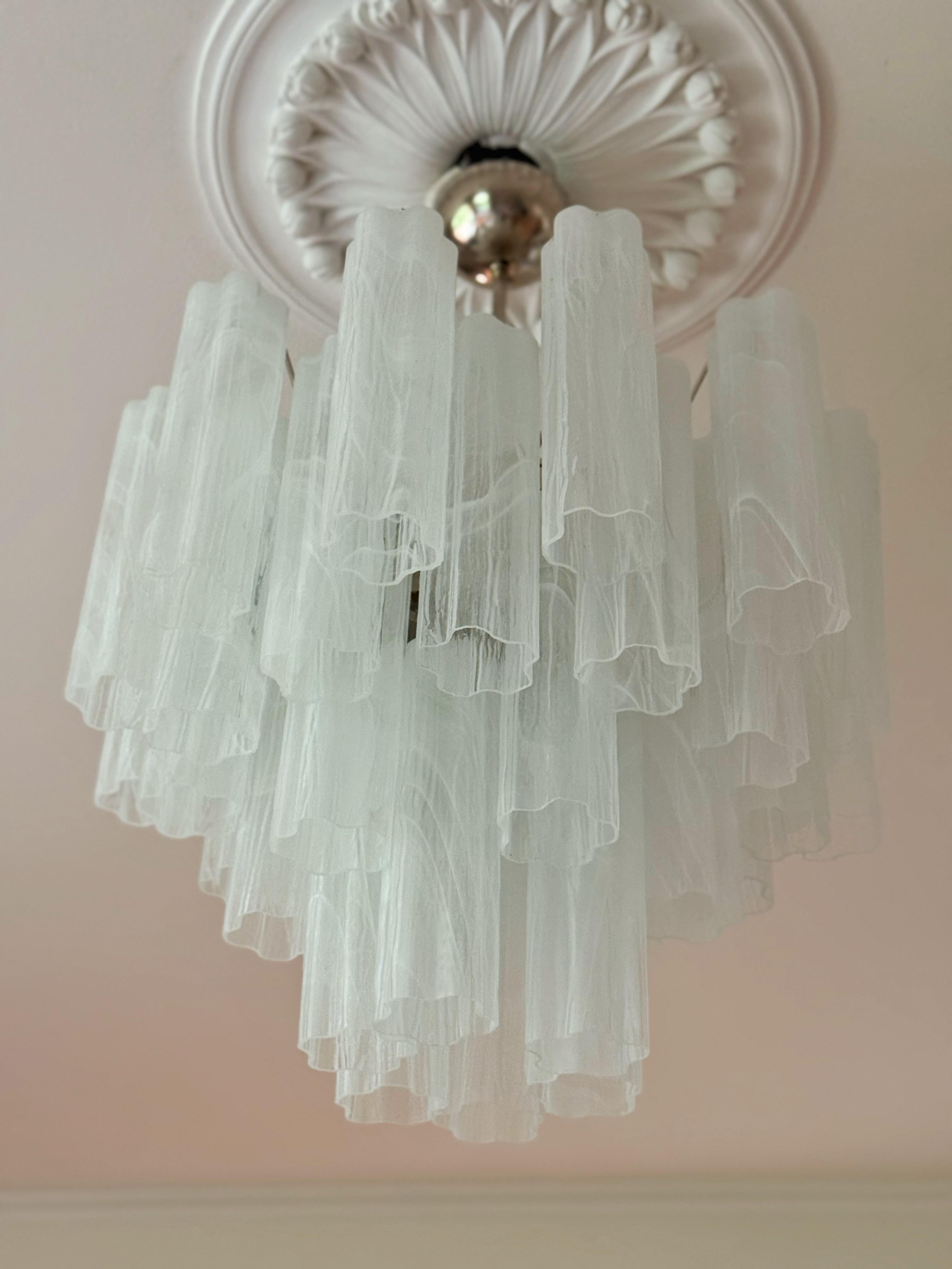 Set of four (4) Elegant, Bold White Murano Chandeliers. Tubular Tronchi Formed Glass Prisms in white tones with a swirled marble pattern. Traditional Italian Mid-Century Style.
The murano fixtures are composed of 36 Glass Elements in the size of 25