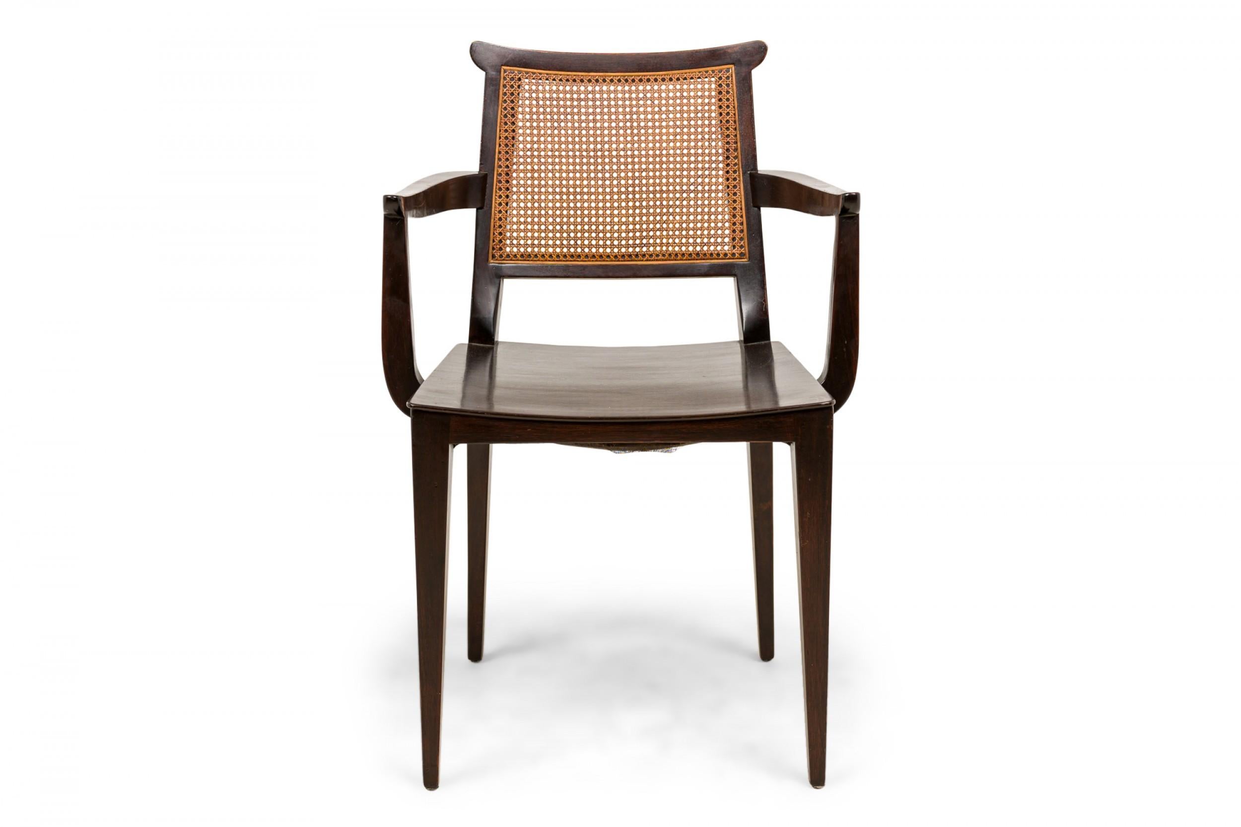 SET of 4 American Mid-Century dining armchairs with dark stained wooden frames, solid wooden seats, and caned backs. (EDWARD WORMLEY FOR DUNBAR FURNITURE COMPANY)(PRICED AS SET)
