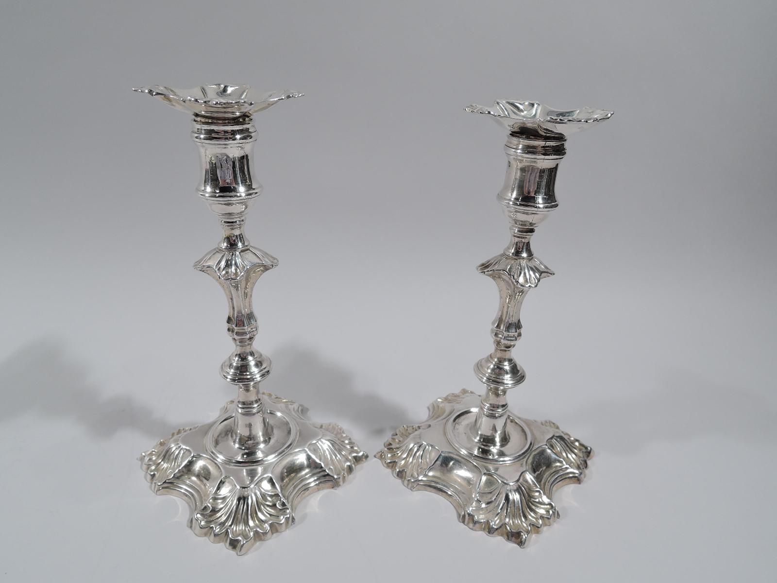 Set of 4 George II cast sterling silver candlesticks. Made by John Cafe in London in 1748. Each: Knopped shaft with leaf flange mounted to inset circle in scroll and leaf quadrilateral foot. Spool socket. Bobeche lobed detachable with leaf corners.