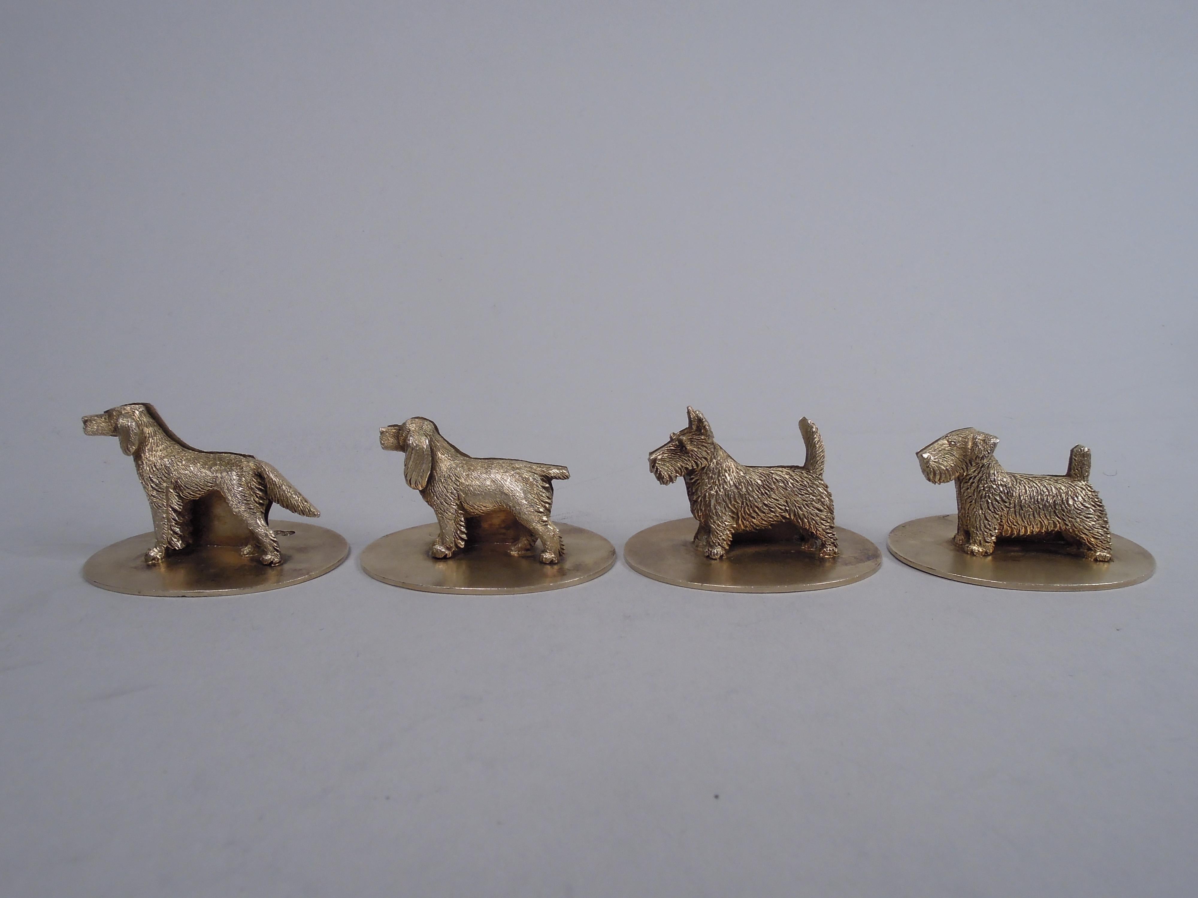 George V sterling silver figural place card holders. Made by William Suckling, Ltd in Birmingham in 1931 Each: Cast canine figure with plain silhouette back mounted to oval base. Each dog different as they are in real life. For a special “pack”