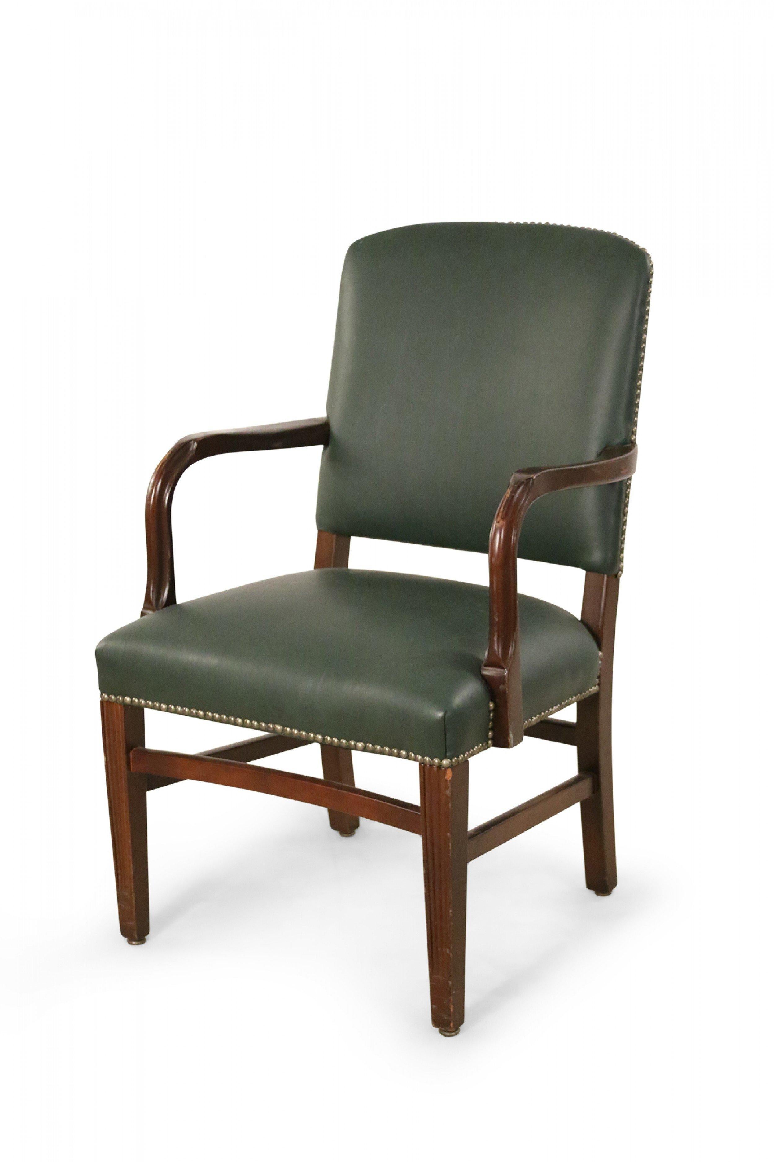 Set of 4 English Victorian-style (20th century) dark green leather armchairs with mahogany wood frames, curved arms, and brass upholstery nail trim. (priced as set).
         