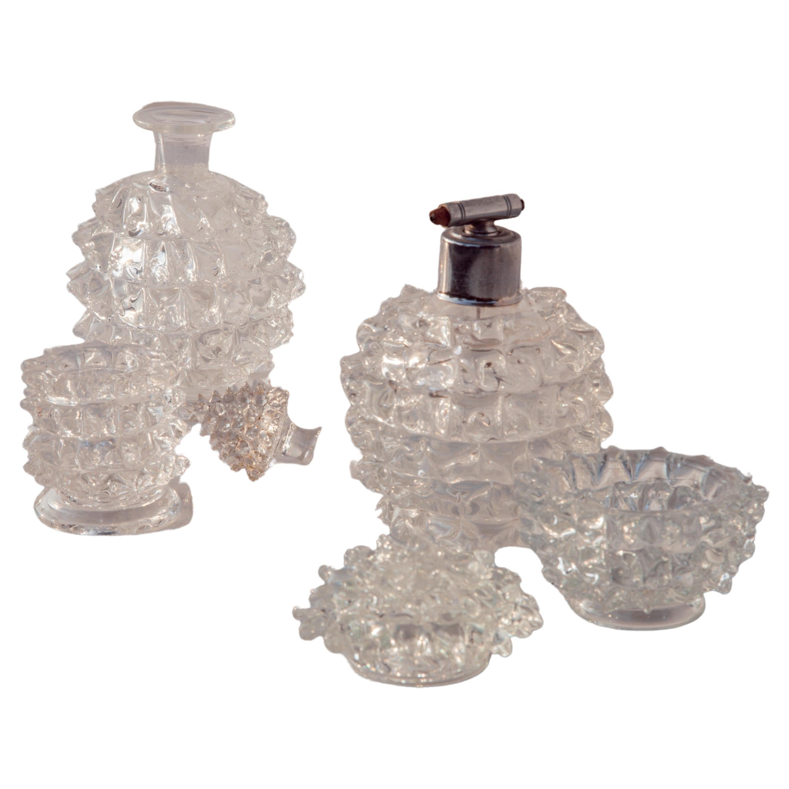 Exquisite and unique rare set of 4 vases attributed to Ercole Barovier using the Rostrato glass technique.

The set is sold in its entirety and includes 4 pieces.

Bottle with stopper:

h 17 cntimeters
diameter 10 centimeters

Perfume vase:
h13 
D.