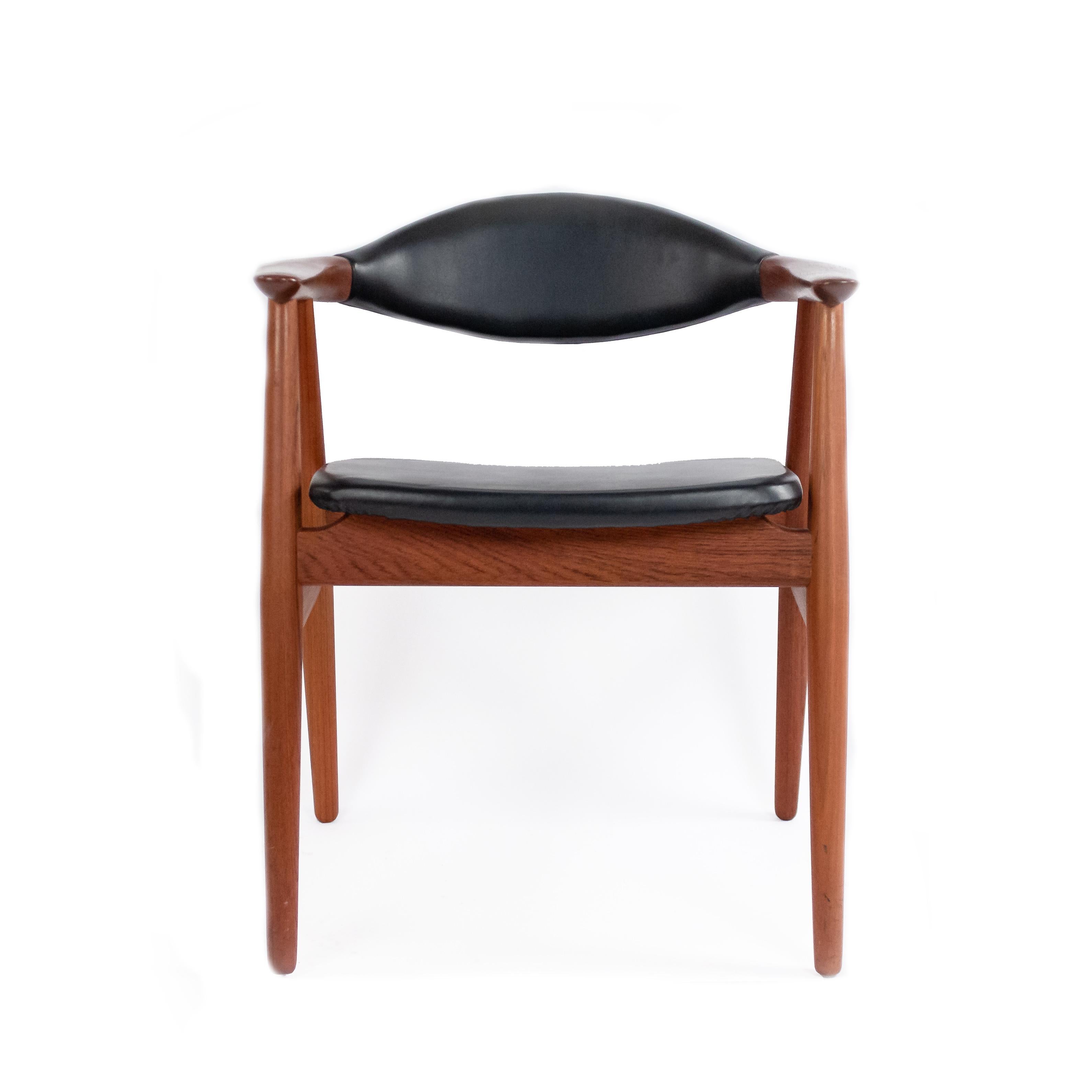 Set of 4 midcentury Danish black vinyl and teak side chairs. Glostrup Mobelfabrik (Maker), Erik Kirkegaard (Designer).