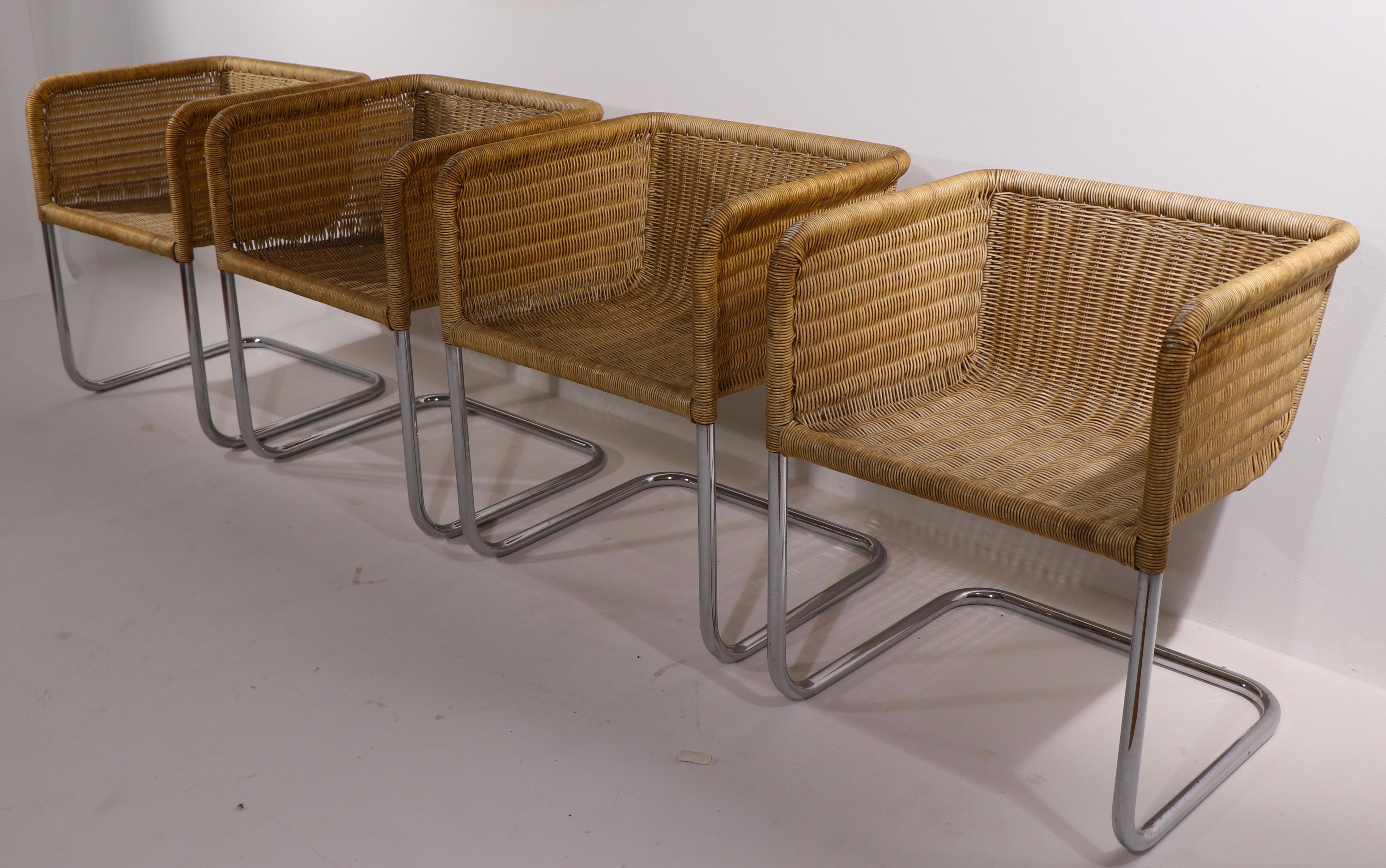 Chic, architectural set of iconic D 43 dining chairs, by Fabricius and Kastholm for Harvey Probber. All four are in good condition, free of damage to the chrome or wicker. The wicker finish has faded over time, to create a nice weathered, but not