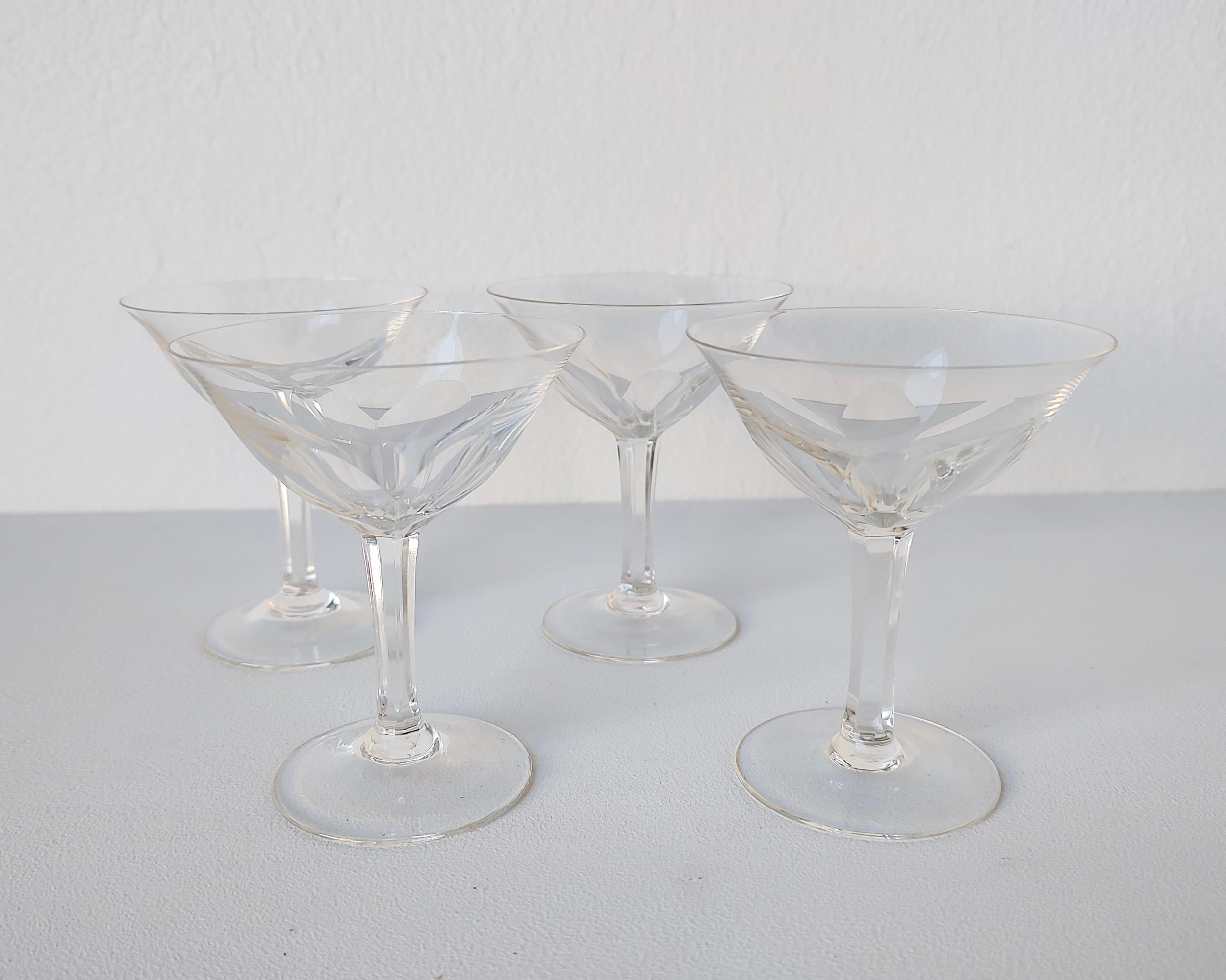 Beautiful faceted and polished cordial champagne glasses in the style of Val Saint Lambert's Gevaert Collection. There is no makers mark but they are in the style of the champagne or sherbet glasses of the famous maker's collection. Holds