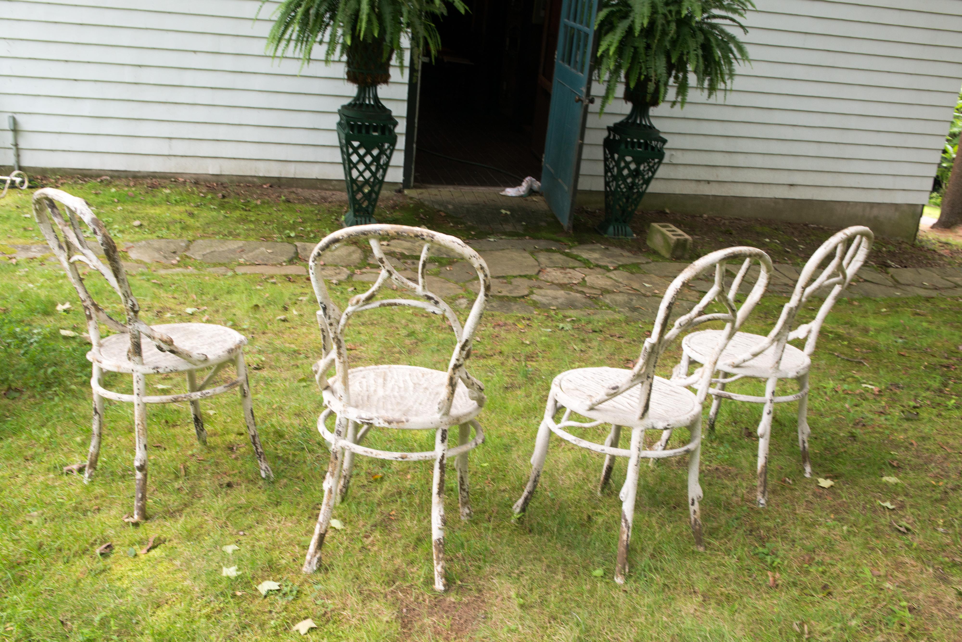 Lovely patina on this set of faux bois finish metal garden chairs. Deliberate distressed finish.