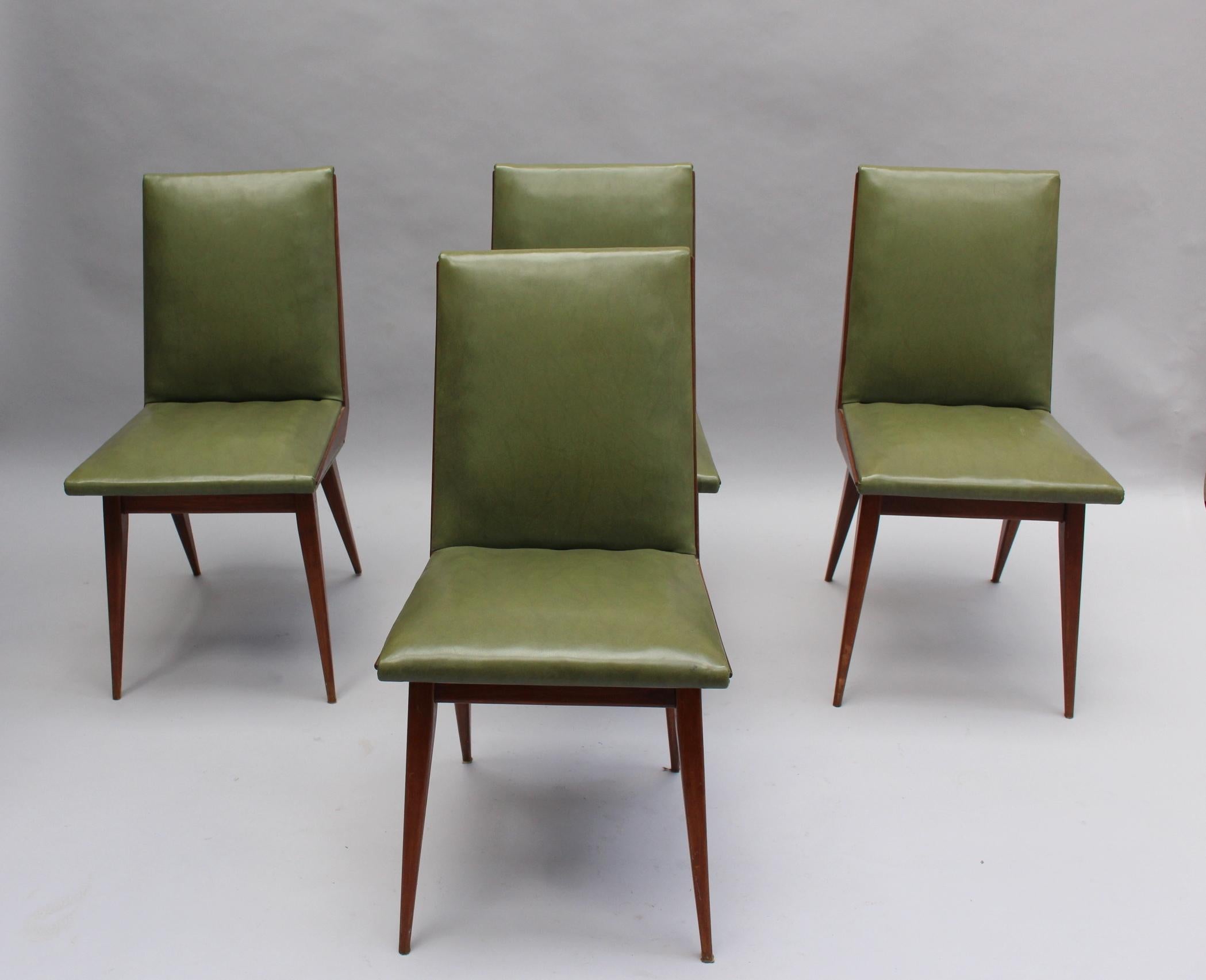 In stained beech, upholstered with the original green leatherette.