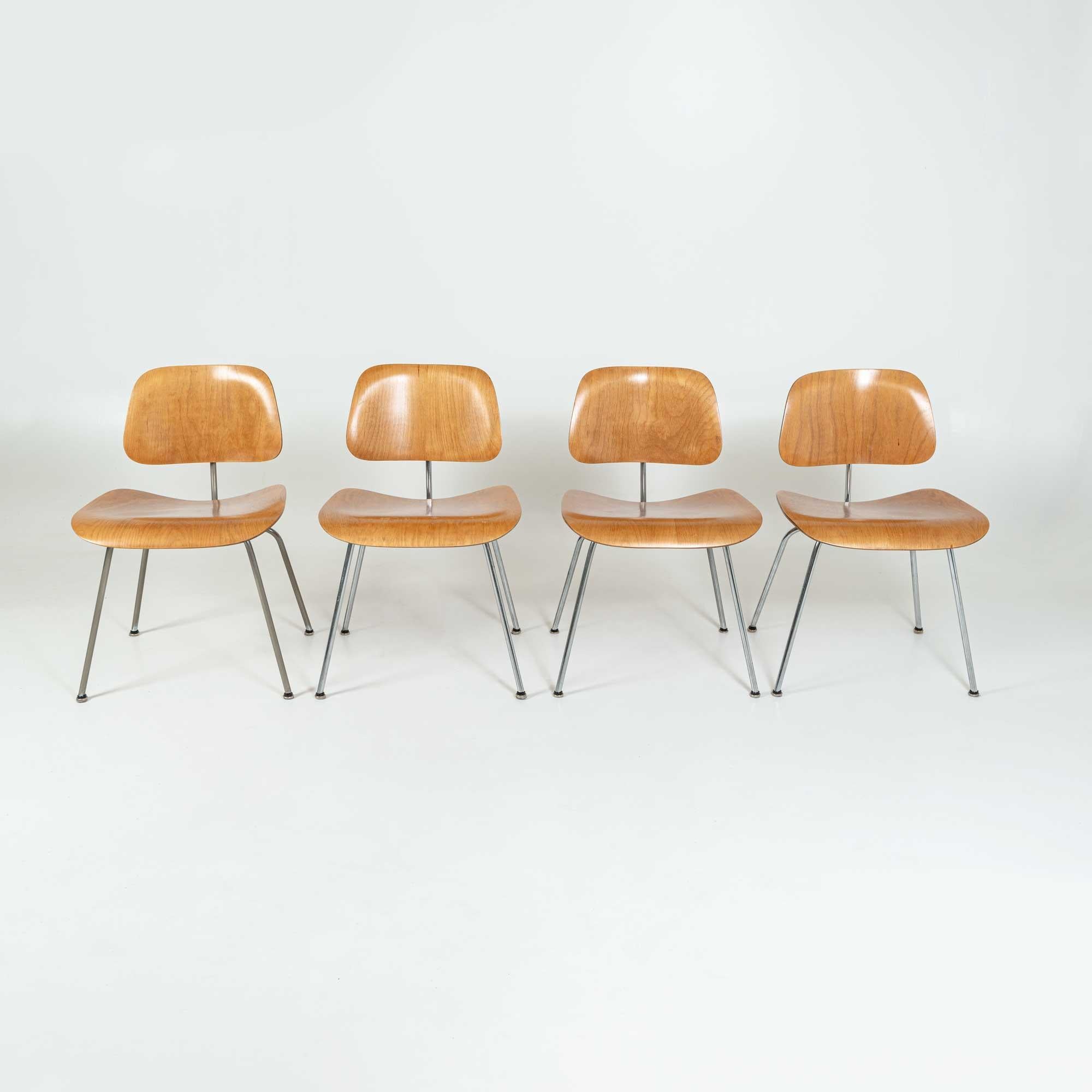 Four Early DCM chairs designed by Charles & Ray Eames for Evans, distributed by Herman Miller. Labels remain intact on all four chairs. Shock mounts has been replaced and the chairs have been previously refinished.
Overall they are all in great