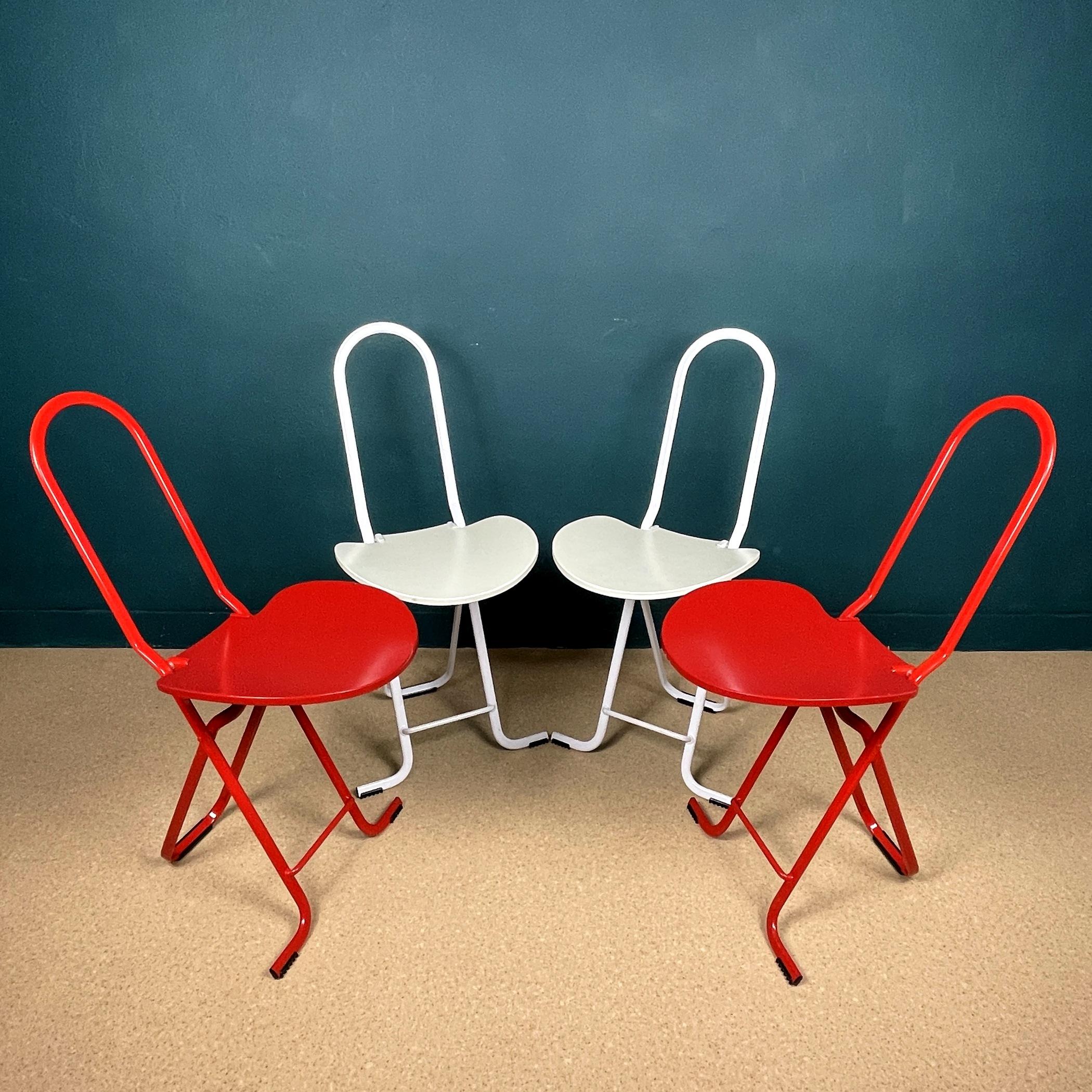 These sleek, practical Dafne folding chairs were designed by Gastone Rinaldi for Thema Italy in 1979. The chairs are made from white-red painted tubular steel and molded plywood. They are labeled with a sticker underneath and a stamp on the metal