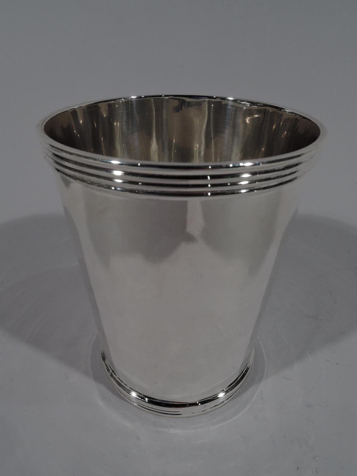 Four American sterling silver mint julep cups. Each: Straight and tapering sides, and reeded rim and foot. A nice starter set in the traditional form. Fully marked including stamp for Frank W. Smith, a Massachusetts maker that was acquired by