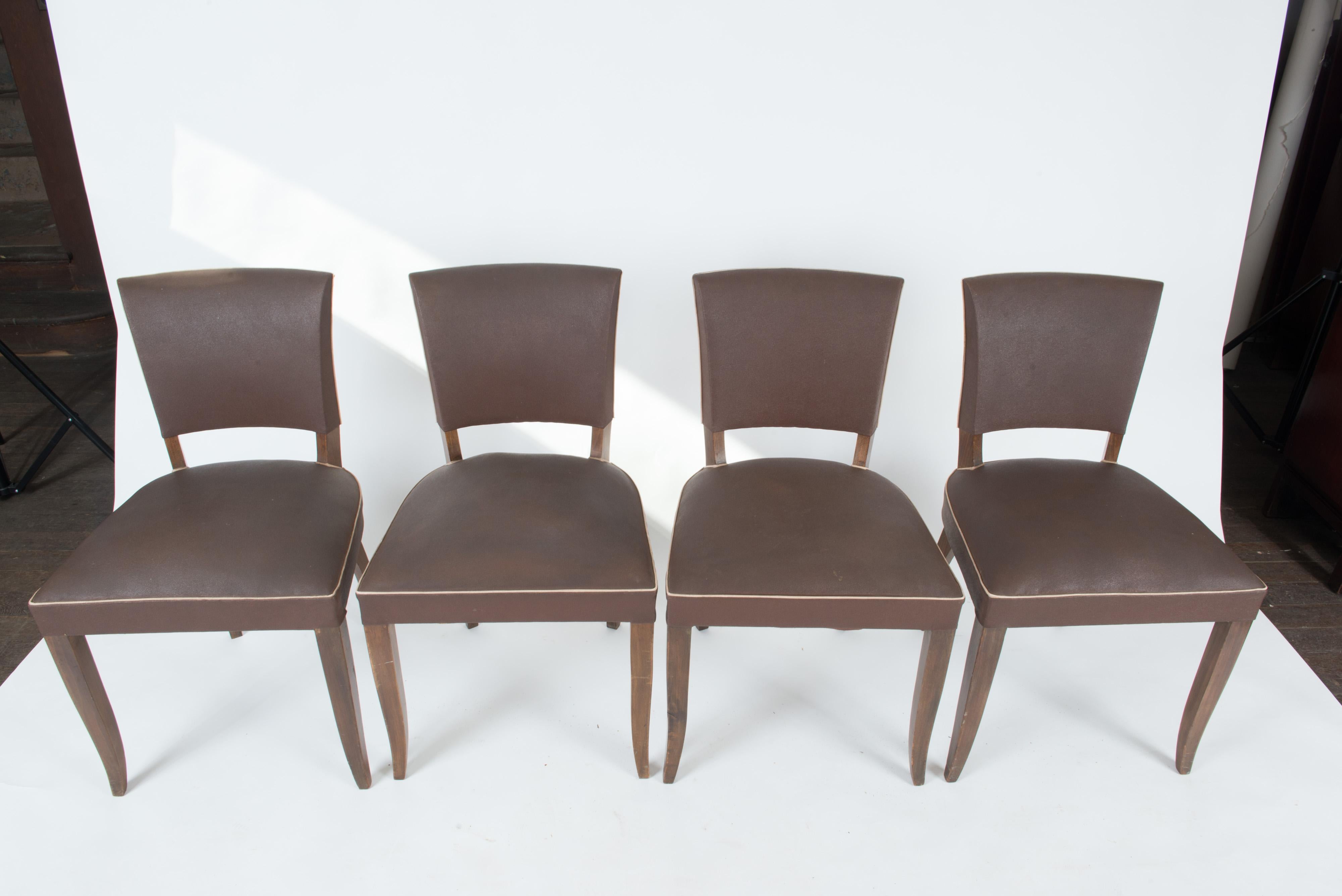 Mid-Century Modern French dining chairs, in original brown vinyl. Solid frames, classic modern style.