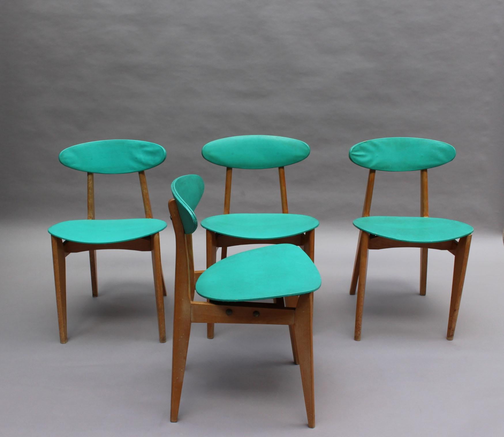 Set of four French Mid-Century beech dining chairs designed by Roger Landault and edited by Robert Sentou.