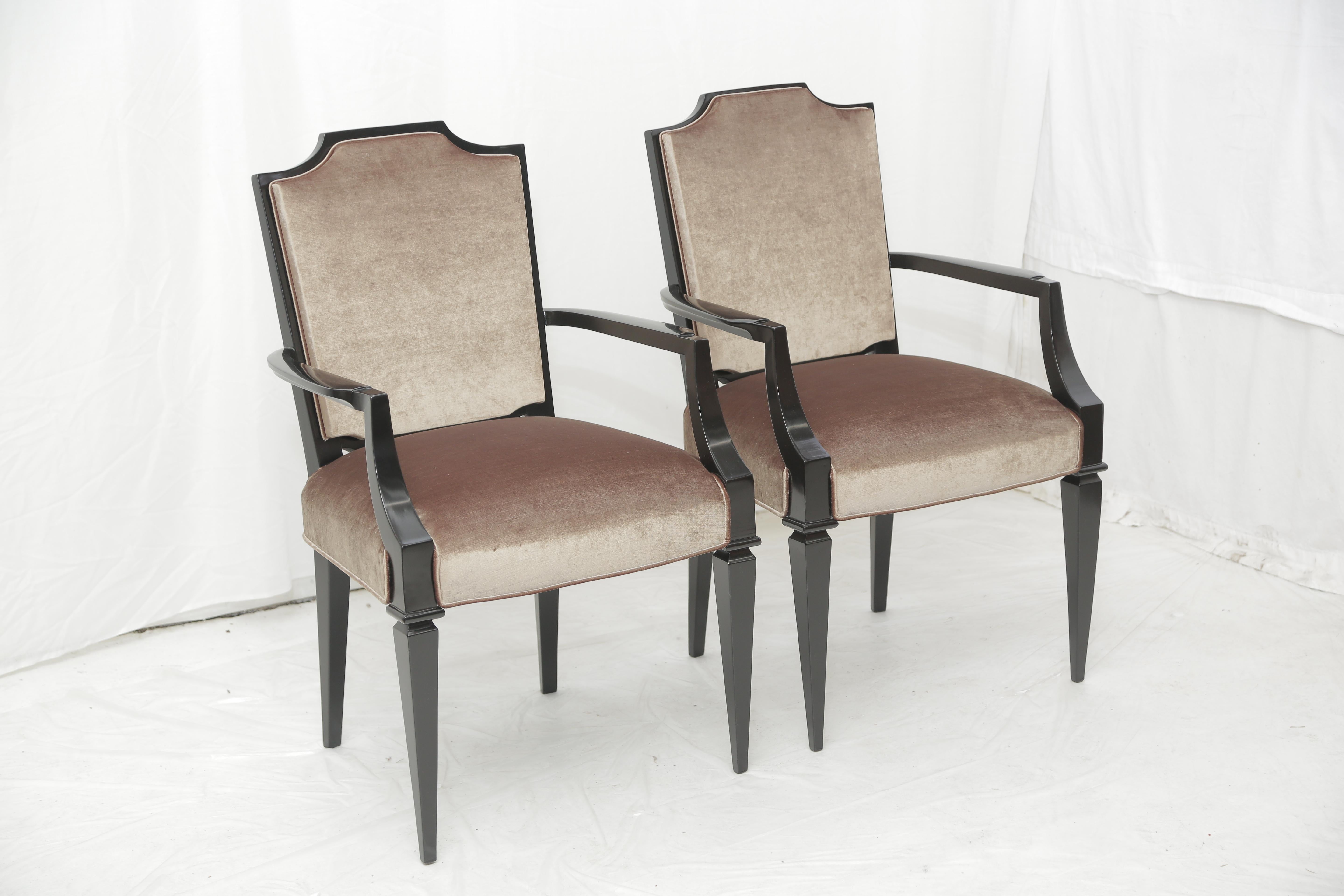 Set of four armchairs from the late Art Deco period in the style of André Arbus. Lacquered in a semi gloss black color, circa 1940.
The chairs have been recently reupholstered in a beige velvet fabric. The details of the wood frame are