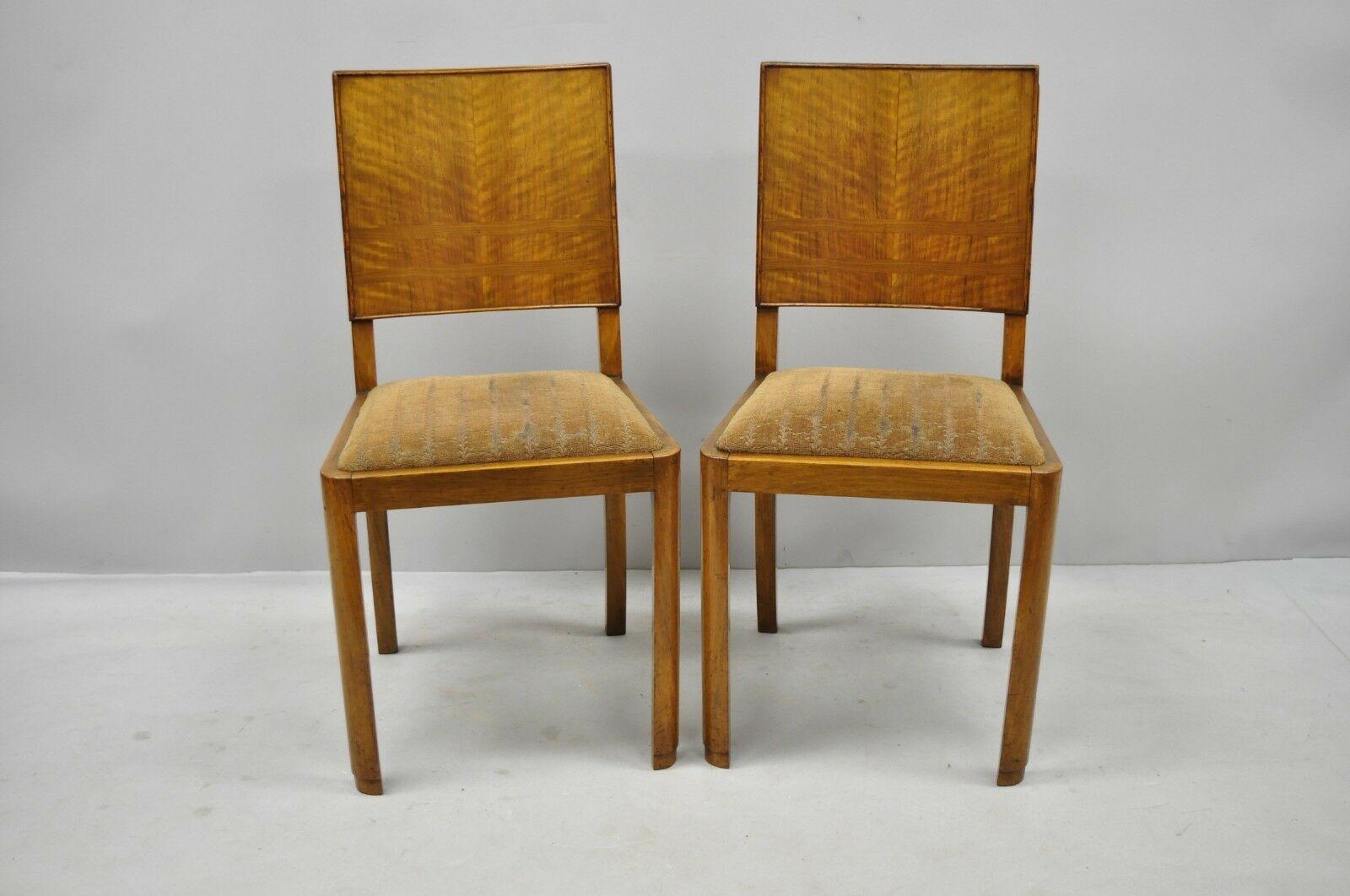 Set of 4 French Art Deco mahogany inlaid dining side chairs. Items feature curved inlaid backs, drop seats, beautiful wood grain, clean modernist lines, circa 1940. Measurements: 35
