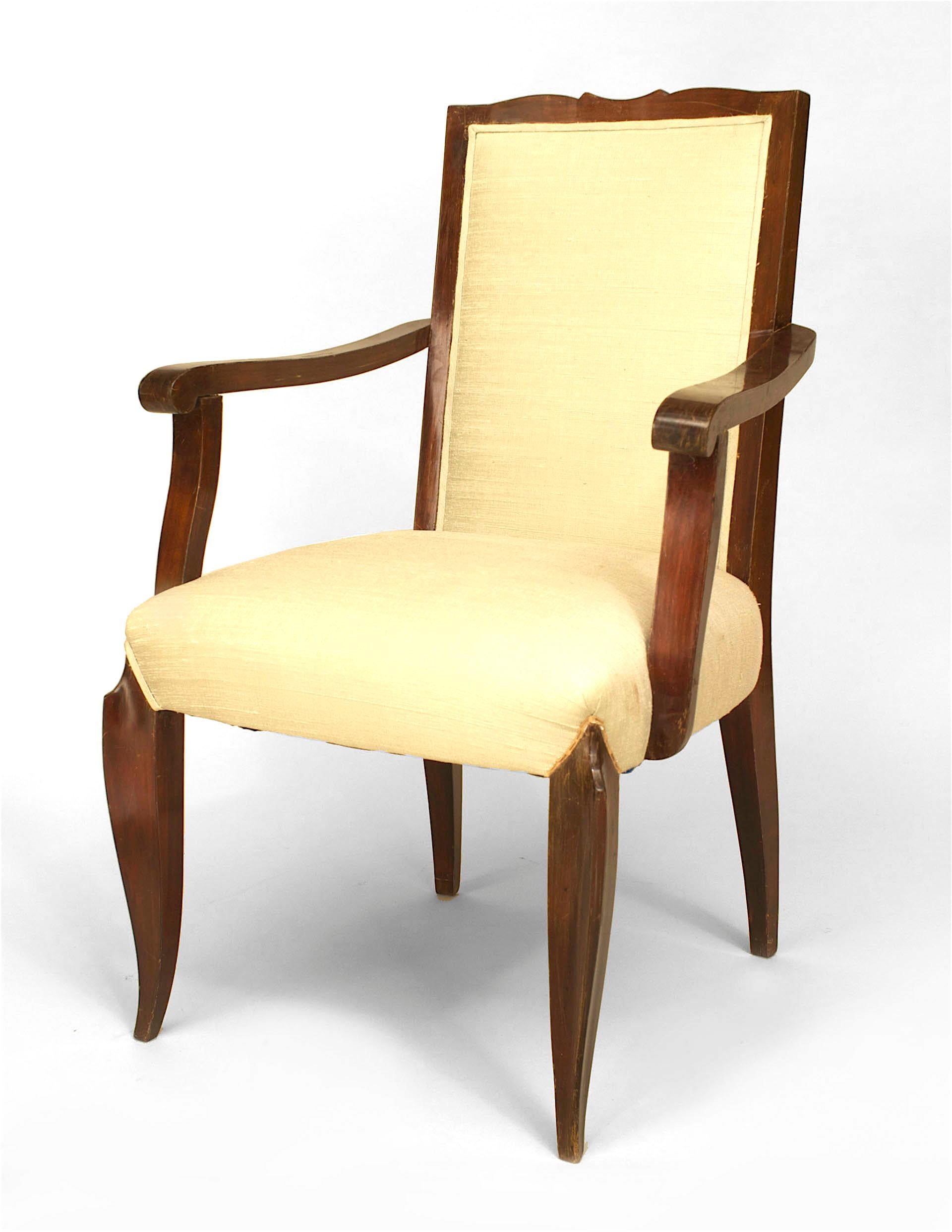 Set of 4 French Art Deco style (1950s) mahogany stained open arm chairs with a shaped back and cream upholstered seat and back. (manner of Jean Pascard)
