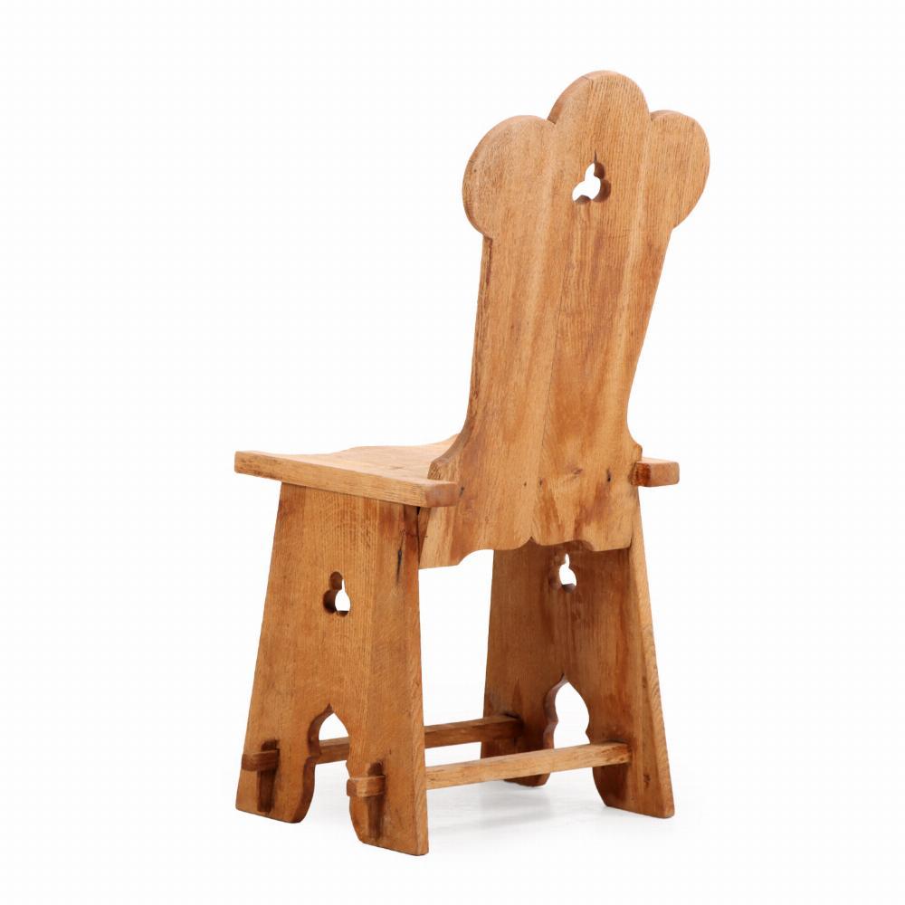 In combination with the solid trefoil carved back rests, the solid seats and splayed legs joined by a lower medial stretcher, these chairs have a geometrical brutalist appearance. 

They are made of solid oak wood and constructed with visible