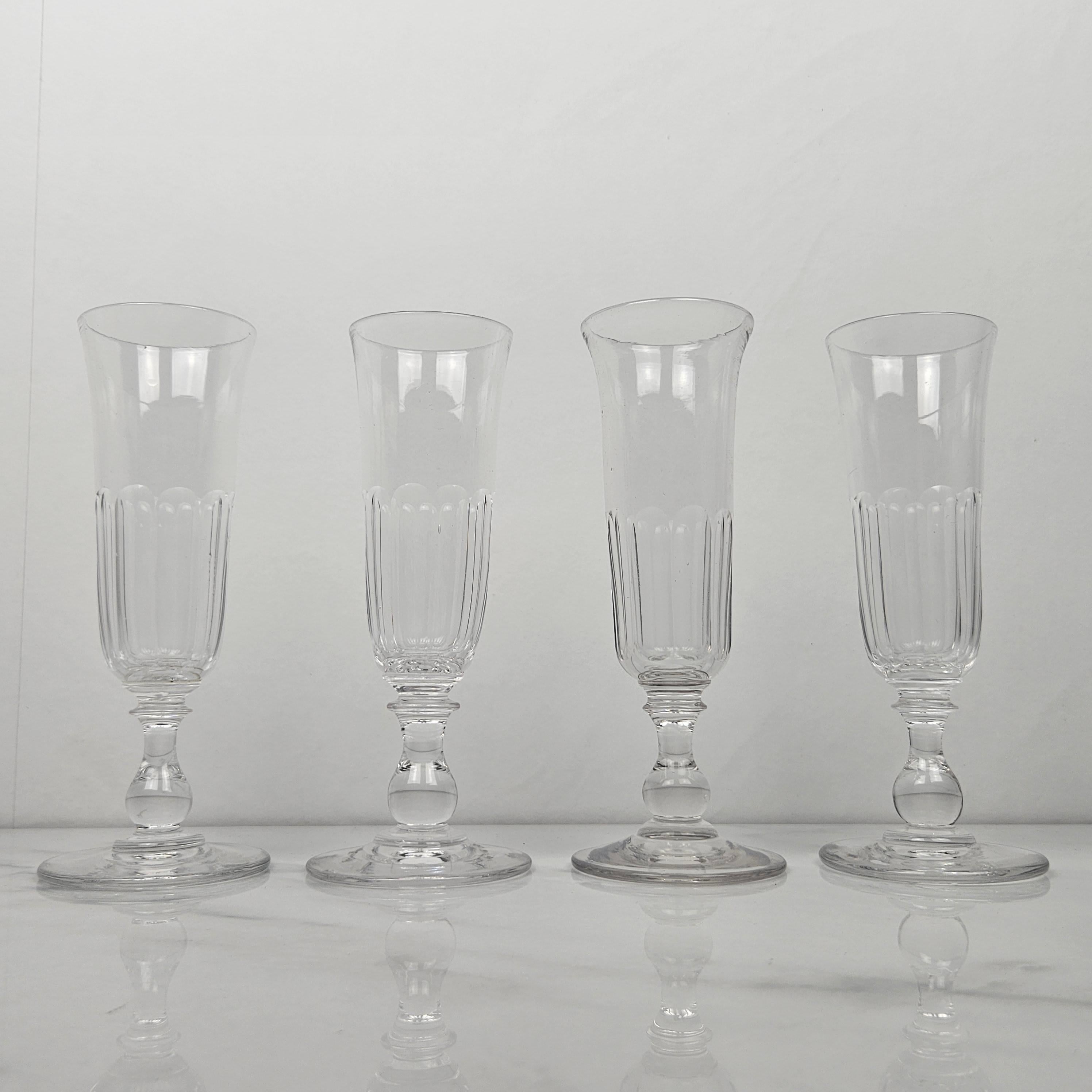 A beautiful set of four handmade French Champagne flutes in crystal glass, fabricated around 1870.  

These antique glasses are mouth-blown. 

Please take notice of the very nice details and the elegant design.
Meticulously handcrafted, these