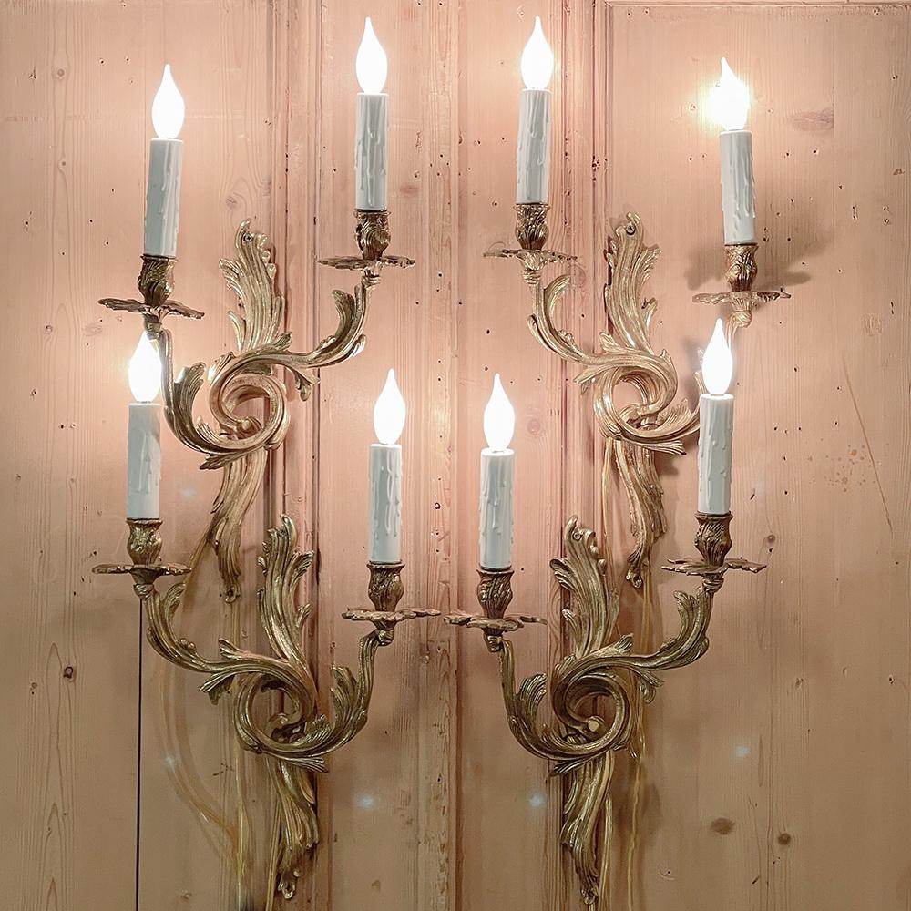 Set of 4 French Louis XV bronze electrified wall sconces are ready to add elegance and flair to any room! Ideal for areas that require symmetry, there are two 