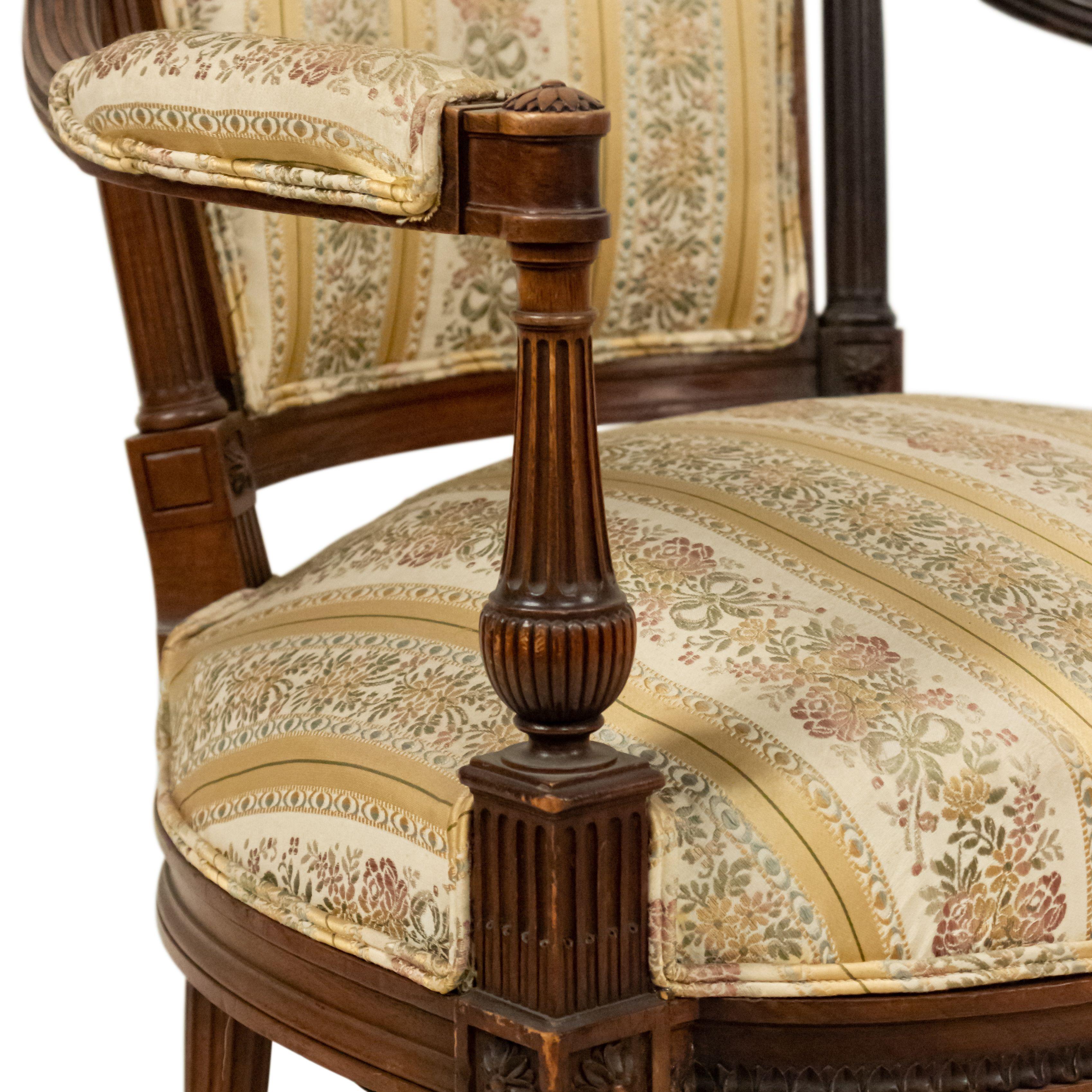 Set of 4 French Louis XVI style walnut arm chairs with striped upholstered seat and back. (19/20th Cent.).
 