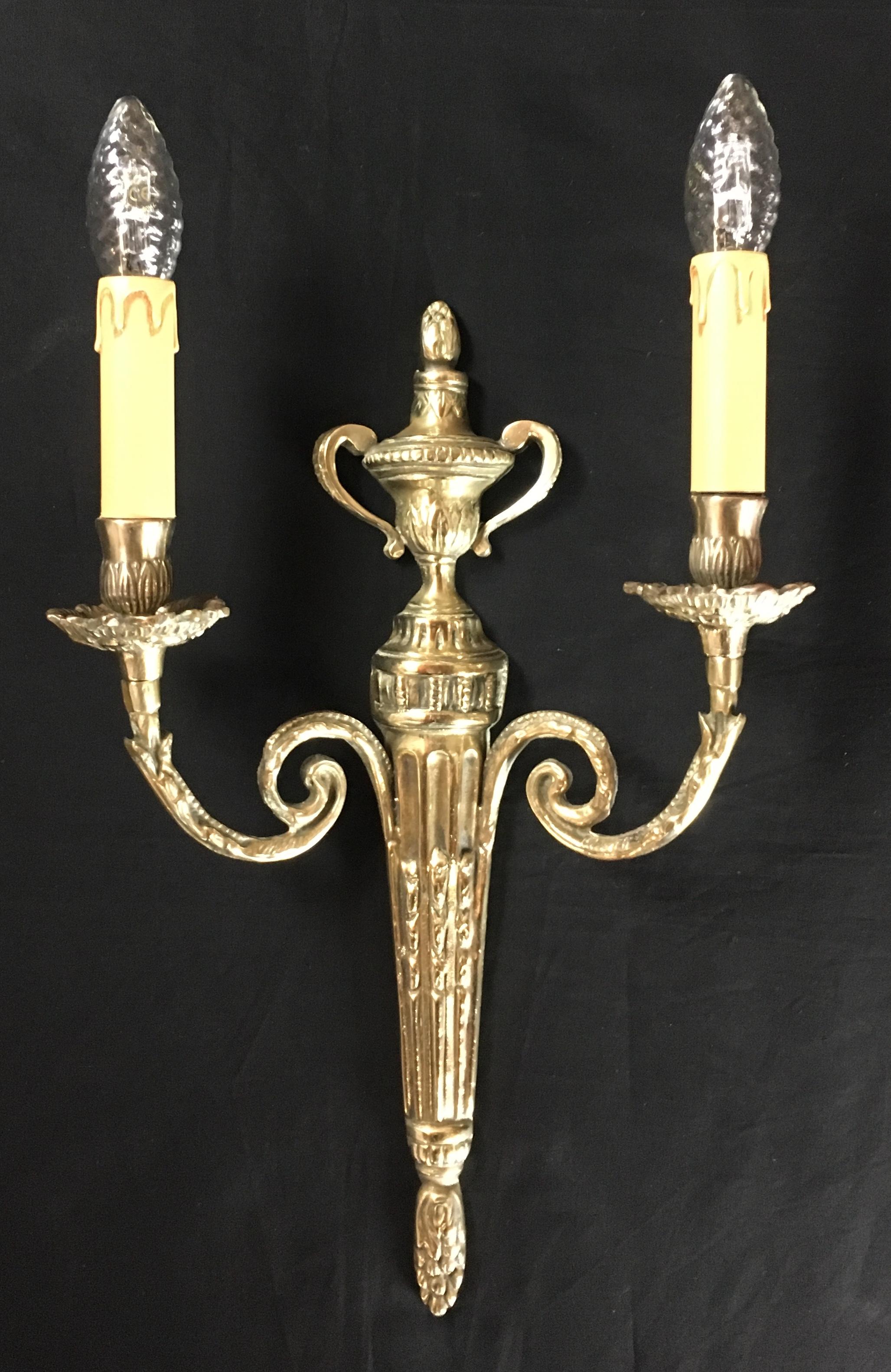 A fine set of 4 Louis XVI - neoclassical style bronze two-armed wall sconces in original form.

These very decorative wall lights have a beautiful finish and patina and would look great in modern, contemporary or traditional homes.

Measures: Height