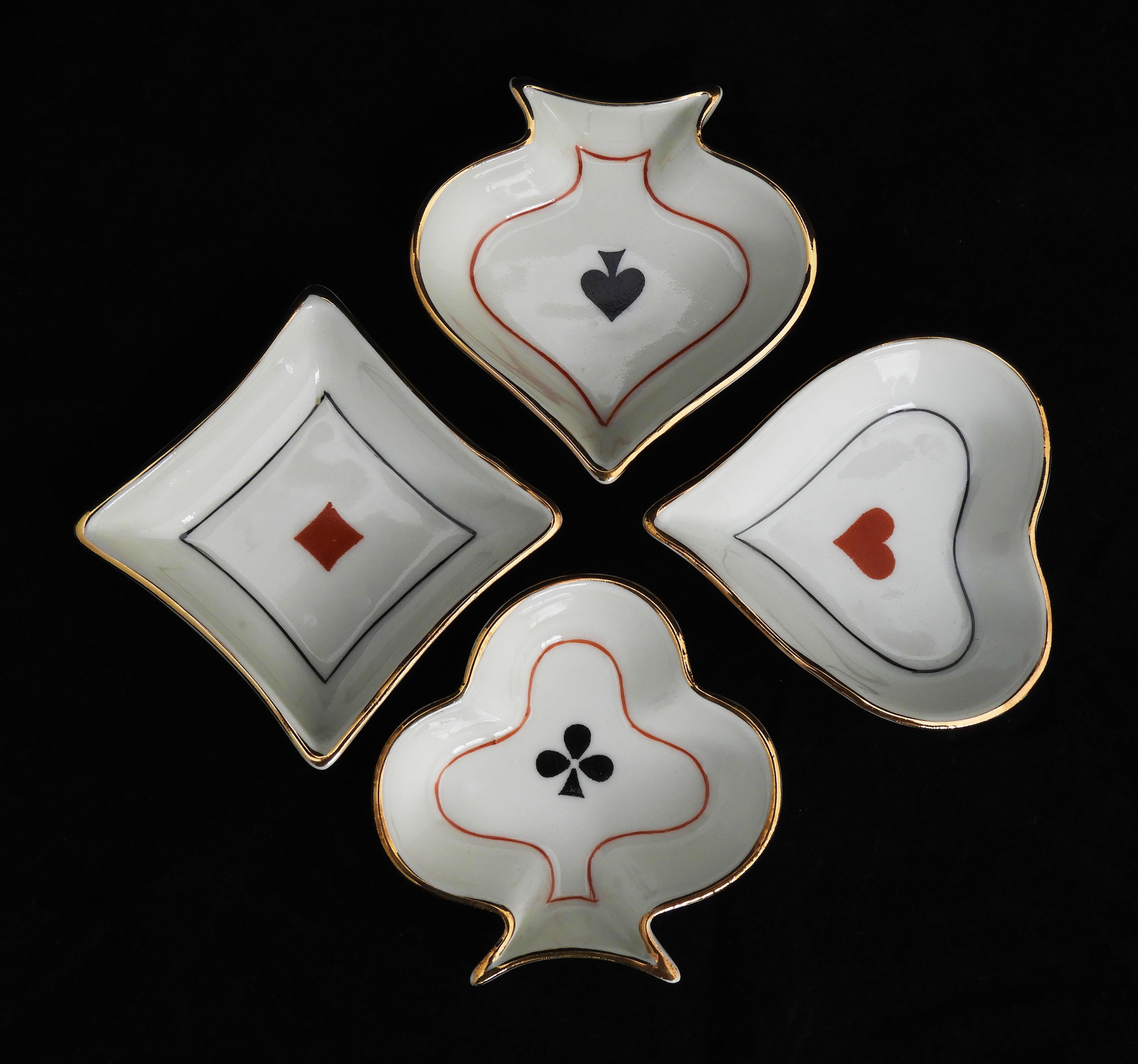 Charming set of 4 vintage playing card-themed trinket dishes/ashtrays from Limoges, France circa 1950.   
Four hand-decorated Limousine porcelain dishes in heart, diamond, spade and club form.  Originally designed to accompany bridge games, these