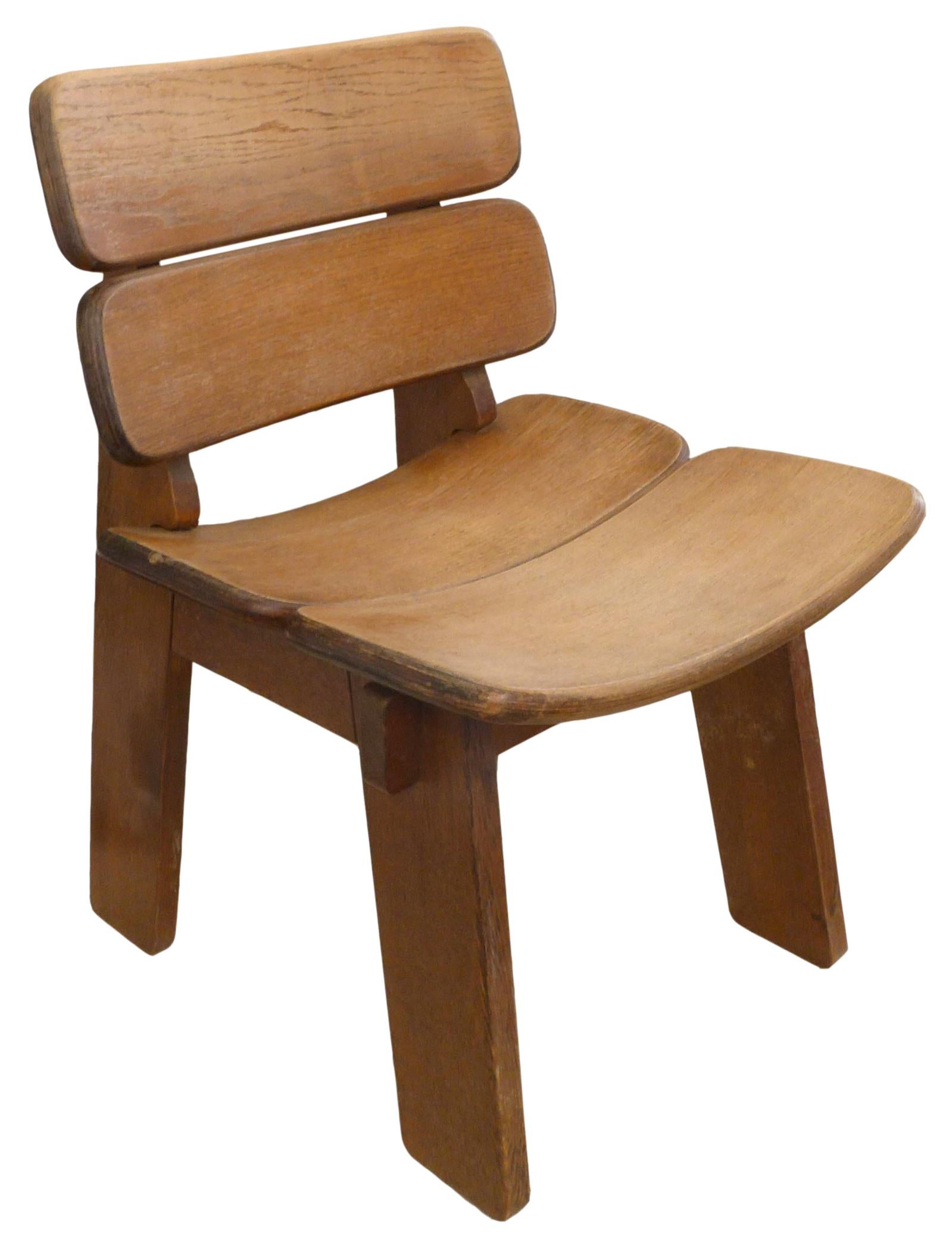 An exceptional set of 4 French, oak, constructivist occasional chairs. A striking set with solid oak frames, split seats and backs of laminated bentwood. Strong and graceful, a sculptural form with splayed legs and rounded details. Seemingly all