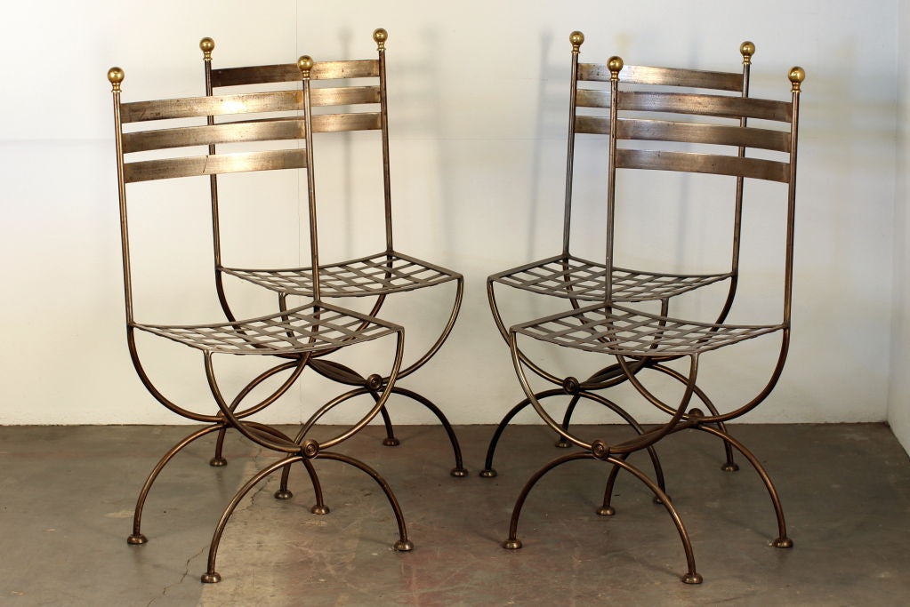 Pair of French polished steel and brass chairs. Standard 18 in. seat height.

Last pair available. Two out of the 4 pictured sold.