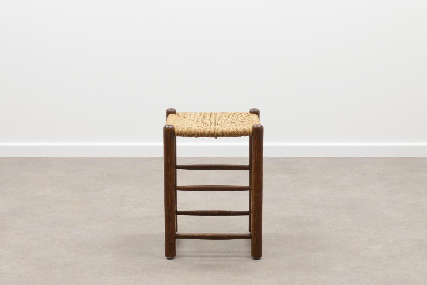 Set of 4 French rush stools in the style of Charlotte Perriand 50s. Solid wood frames and woven rush seat. The stools have some repares and wear, but are fully functional and give a nice wabi sabi feel. Price is for the set of 4. 

 