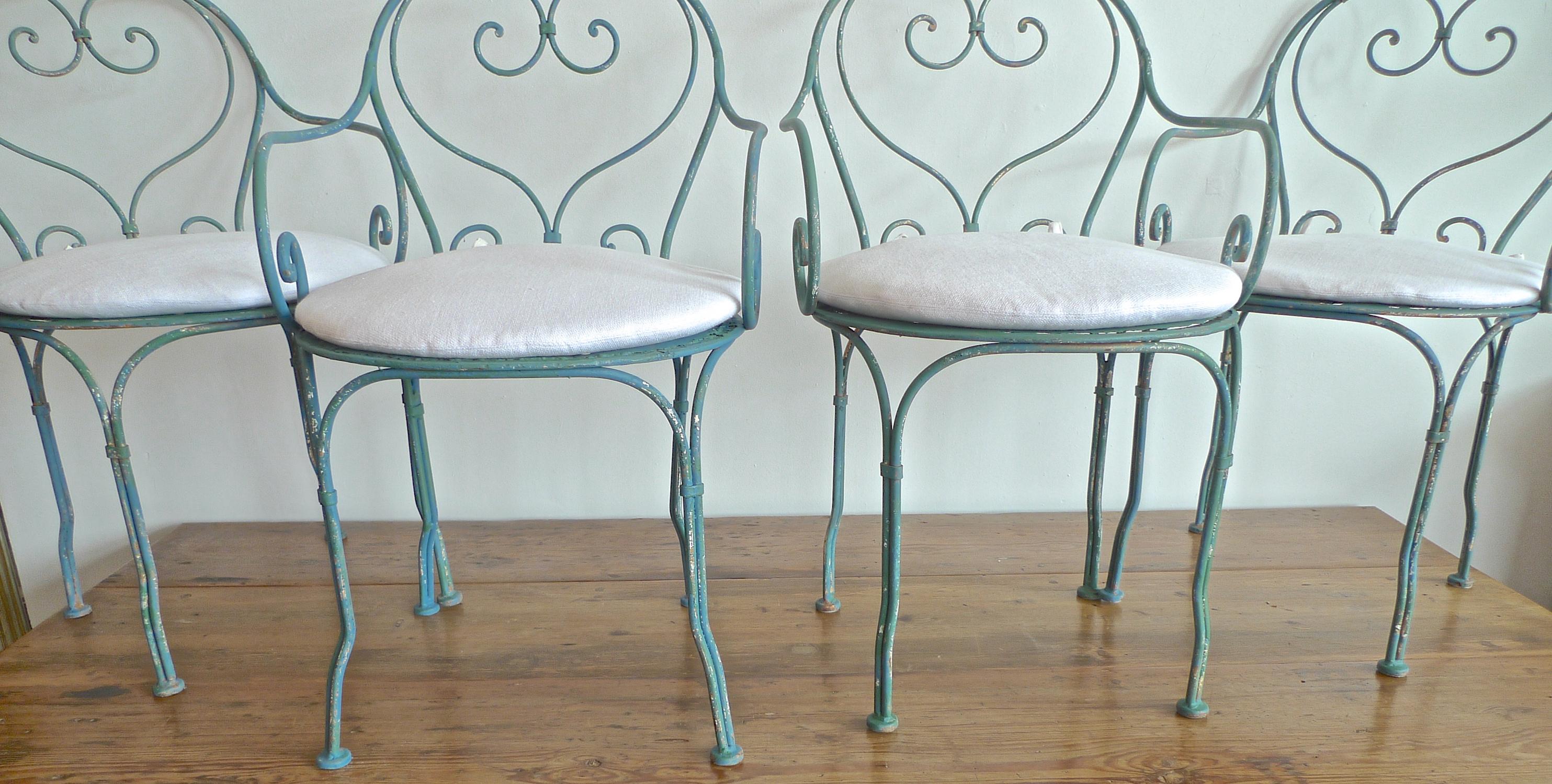 Set of 4 French 19th century painted wrought iron bistro armchairs with cushions.