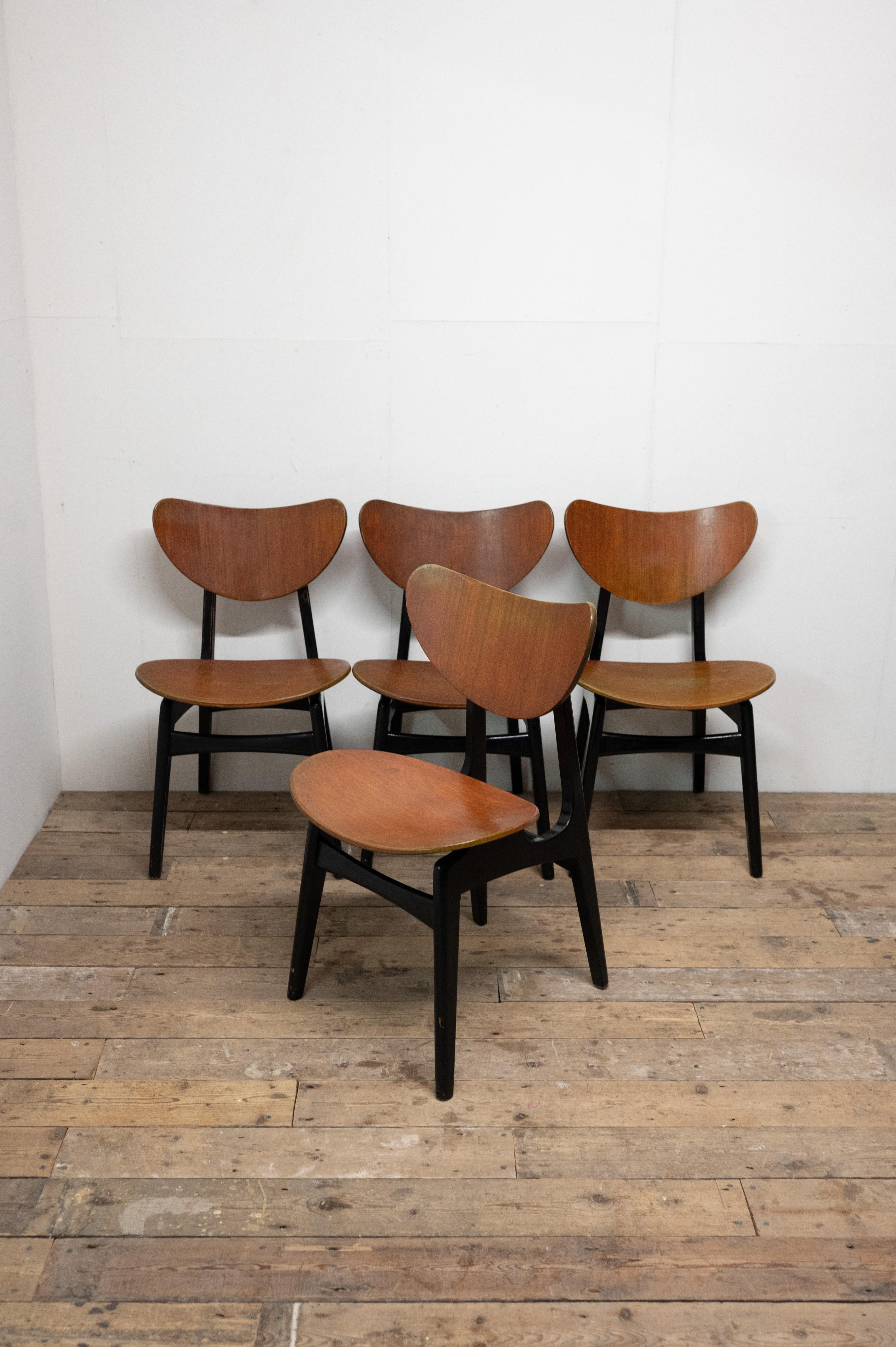 Elevate your dining area with this captivating set of four G Plan Tola Butterfly Dining Chairs, each a testament to the renowned G Plan brand's top-quality British design range.
These chairs, showcasing a mix of aged character and a storied past,