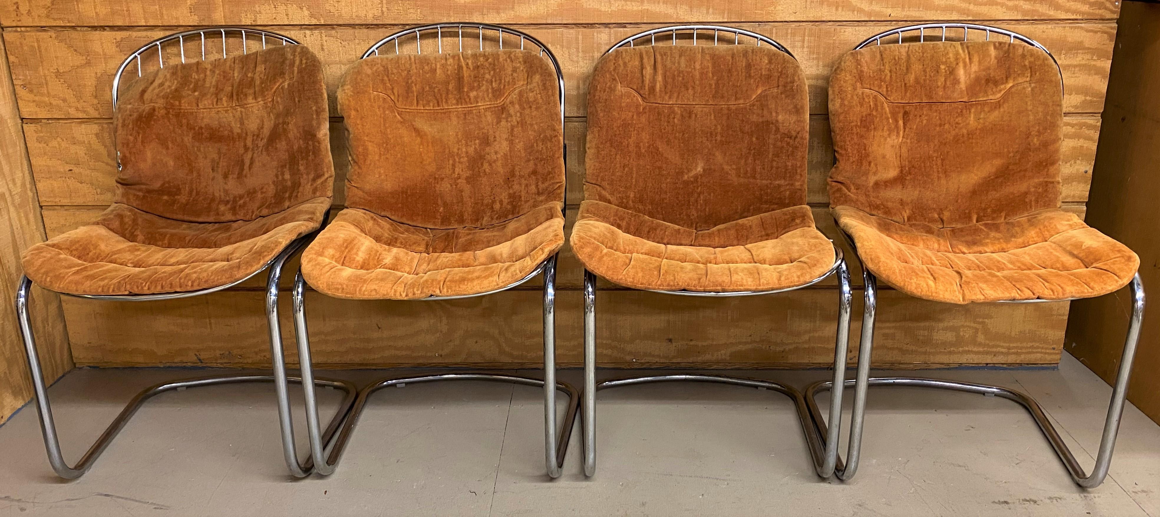 A fine set of four mid century chrome wire dining chairs in the manner of Italian designer Gastone Rinaldi (1920-2006), with original orange cushions, circa 1970’s. Good overall condition, with some minor surface spotting on chrome, as well as a few