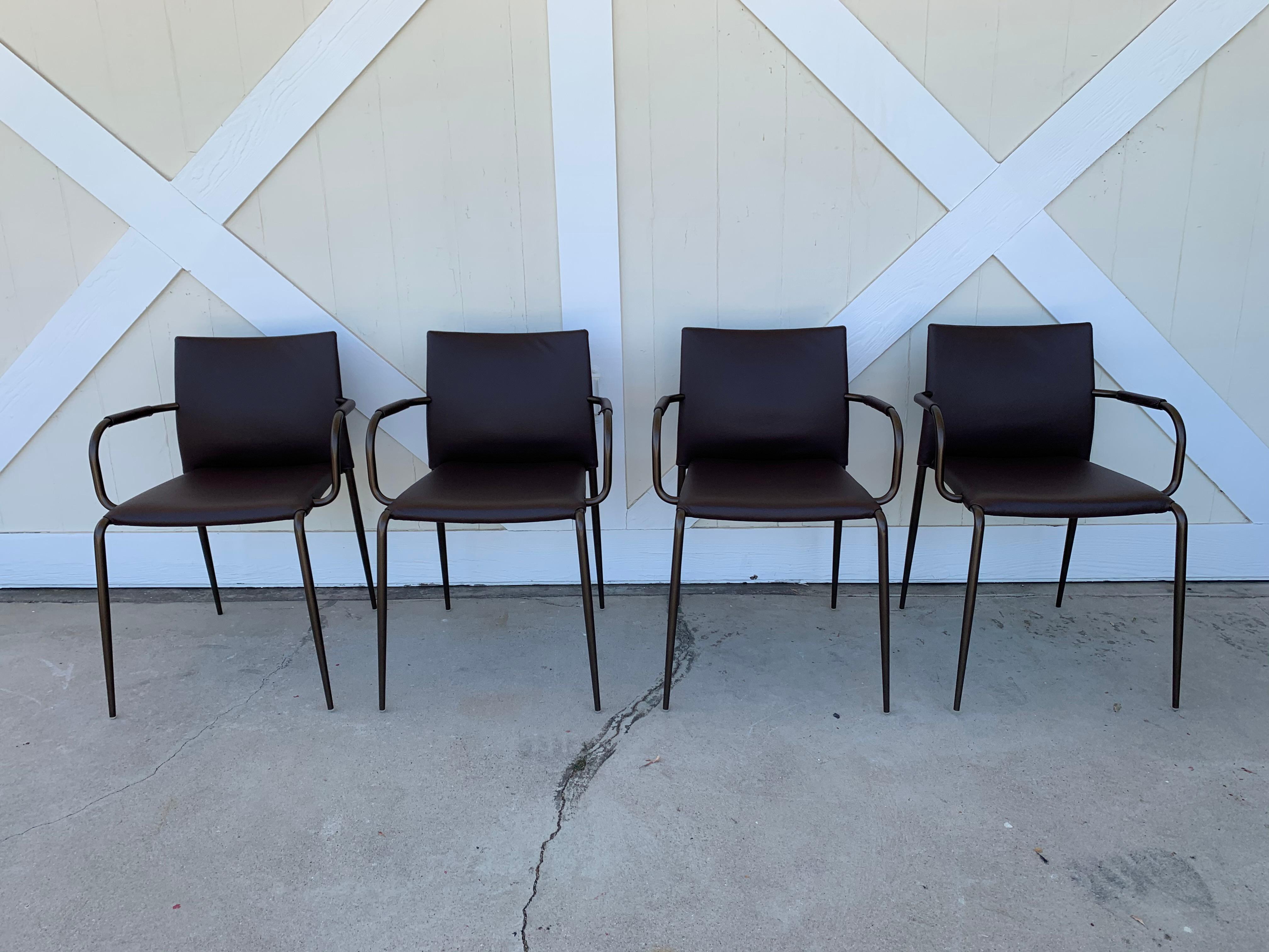 Set of four Gazzella carmchairs designed by Tom Kelley and manufactured in Italy by Enrico Pellizzoni.

This armchair is characterized by Minimalist, simple lines synonymous with great elegance. It's stackable and suitable for all contexts, from