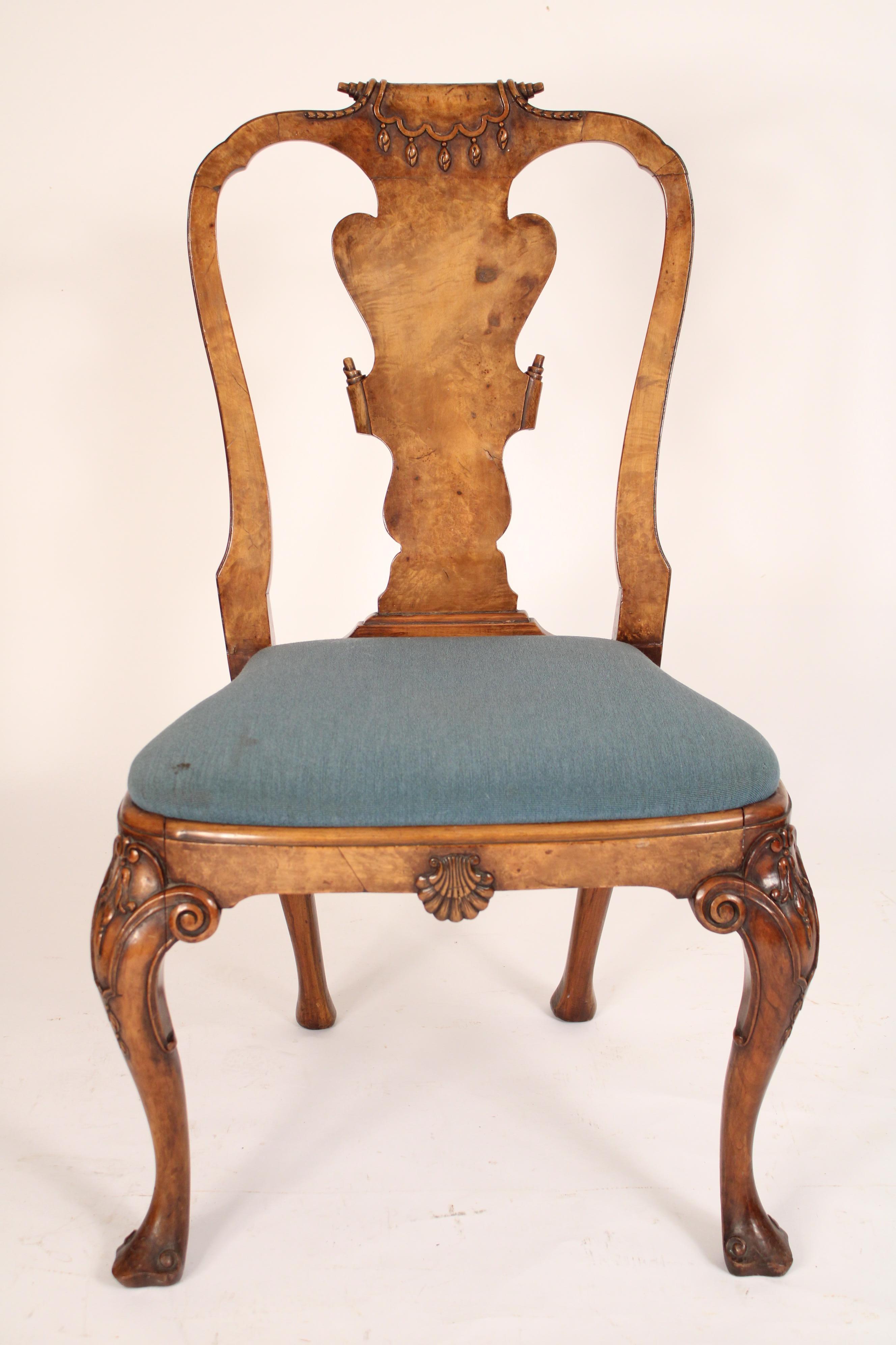 Set of 4 George I style walnut and burl elm side chairs, circa 1920's. The crest rail with a central carved scroll, a burl elm vase shaped back splat with carved scrolls on right and left sides, back of back splat has a deep bevel, front seat rail