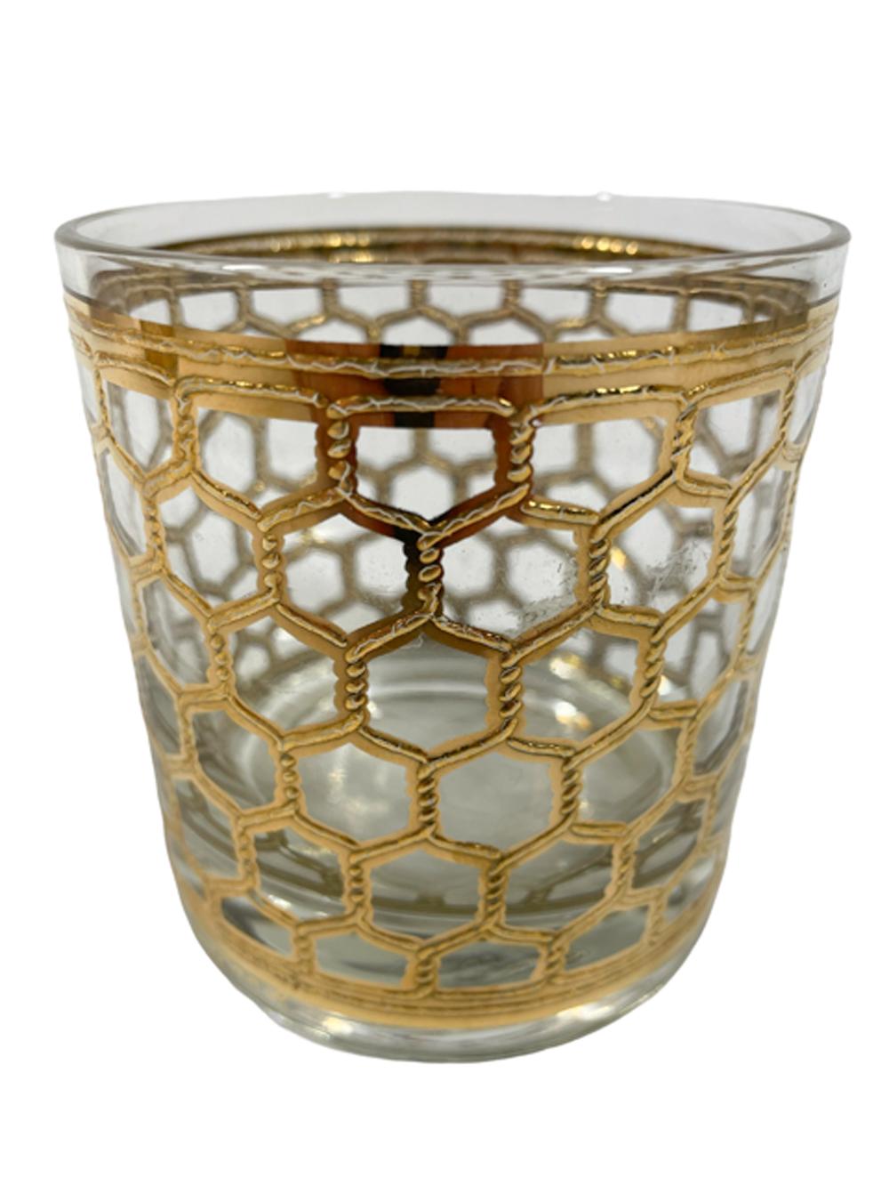 Georges Briard rocks glasses decorated in a raised hexagonal wire screen pattern executed in 22 karat gold.